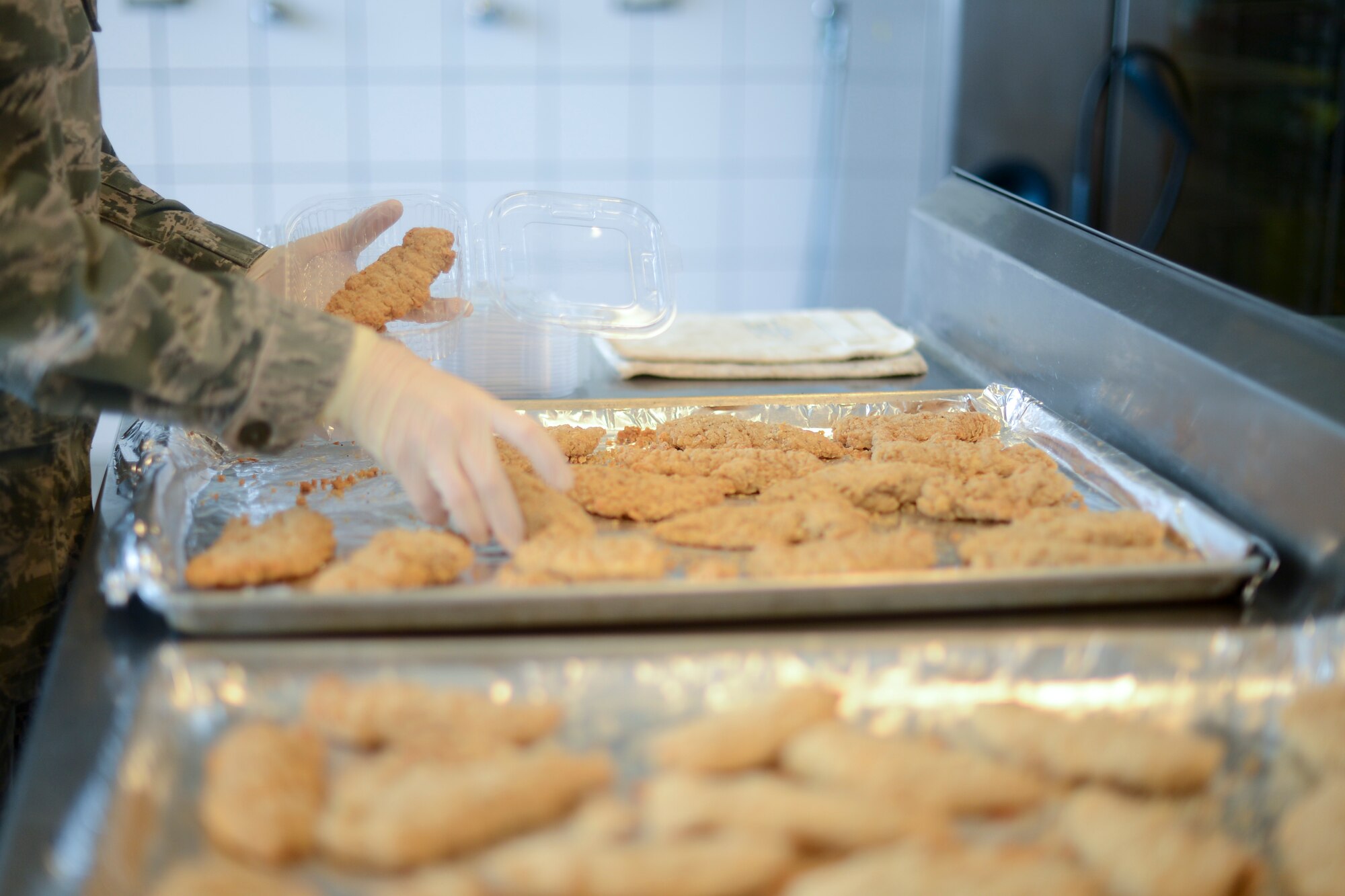 Airman First Class Amanda Jolly, 786th Force Support Squadron services shift leader, prepares flight meals for Airmen on Ramstein Air Base, Germany, July 23, 2014. The 786th Force Support Squadron provides flight meal support for worldwide missions and also ground missions locally. The squadron supplies approximately 250 meals a day, but during the busiest times of the year, they supply around 1,000 meals on an average day. With a small staff, the flight kitchen is able to complete the mission despite many variables such as an increase in world events. They also provide MRE (meals ready to eat) support to units and accomplish stock room operations to keep the mission running smoothly. (U.S. Air Force photo/Airman 1st Class Michael Stuart)