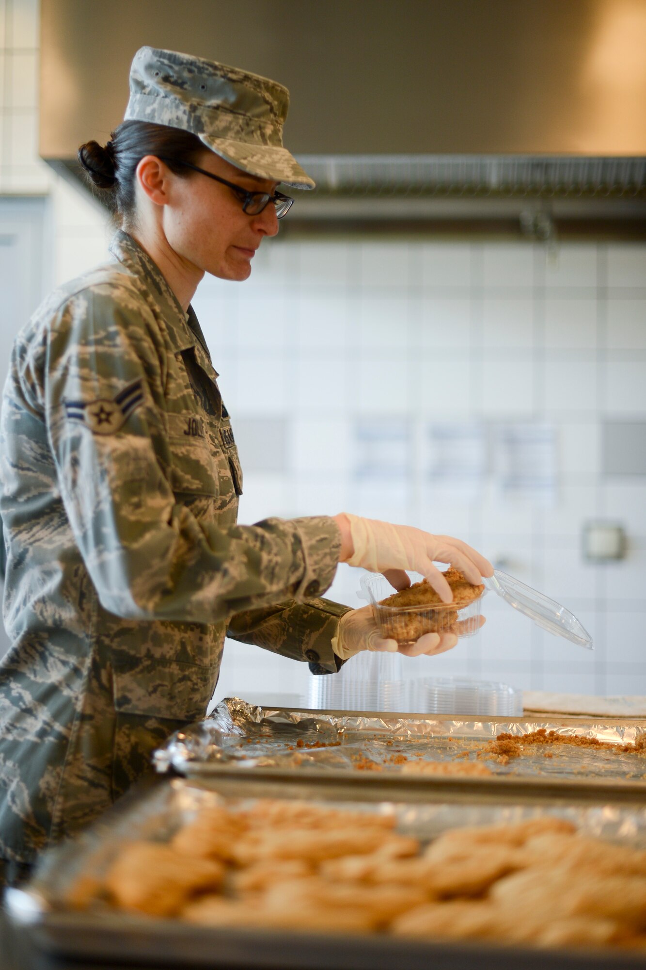 Airman First Class Amanda Jolly, 786th Force Support Squadron services shift leader, prepares flight meals for Airmen on Ramstein Air Base, Germany, July 23, 2014. The 786th Force Support Squadron provides flight meal support for worldwide missions and also ground missions locally. The squadron supplies approximately 250 meals a day, but during the busiest times of the year, they supply around 1,000 meals on an average day. With a small staff, the flight kitchen is able to complete the mission despite many variables such as an increase in world events. They also provide MRE (meals ready to eat) support to units and accomplish stock room operations to keep the mission running smoothly. (U.S. Air Force photo/Airman 1st Class Michael Stuart)