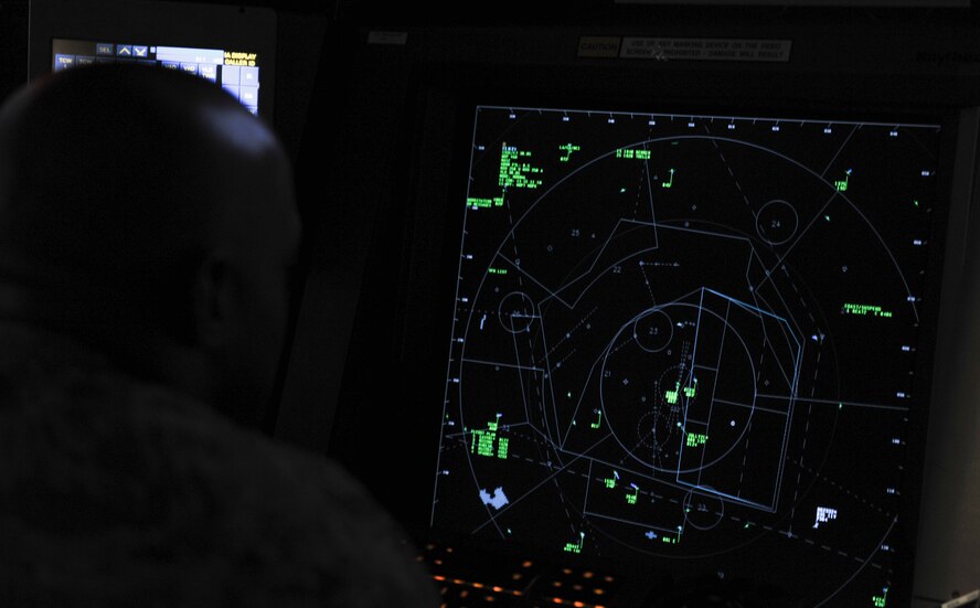 U.S. Air Force Master Sgt. Bryan Greenwood, 23d Operation Support Squadron air traffic control watch supervisor, watches a radar screen at Moody Air Force Base, Ga., July 23, 2014. The radar shows aircraft, both military and civilian, flying within a 60-mile radius. (U.S. Air Force Airman 1st Class Alexis Millican/Released)