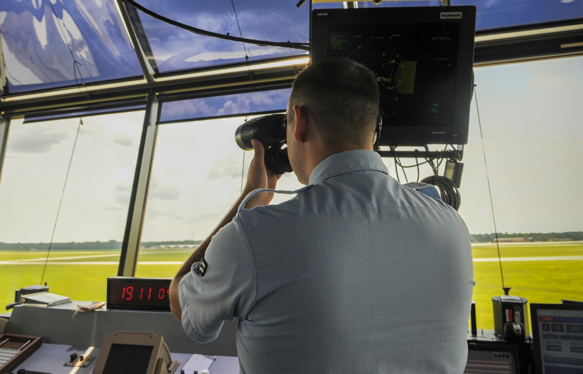 U.S. Air Force Airman 1st Class Noah Carpenter, 23d Operation Support Squadron air traffic control apprentice, makes sure there are no animals or debris on the runway at Moody Air Force Base, Ga., July 23, 2014. Air traffic controllers use radios to communicate with the pilots. (U.S. Air Force Airman 1st Class Alexis Millican/Released)