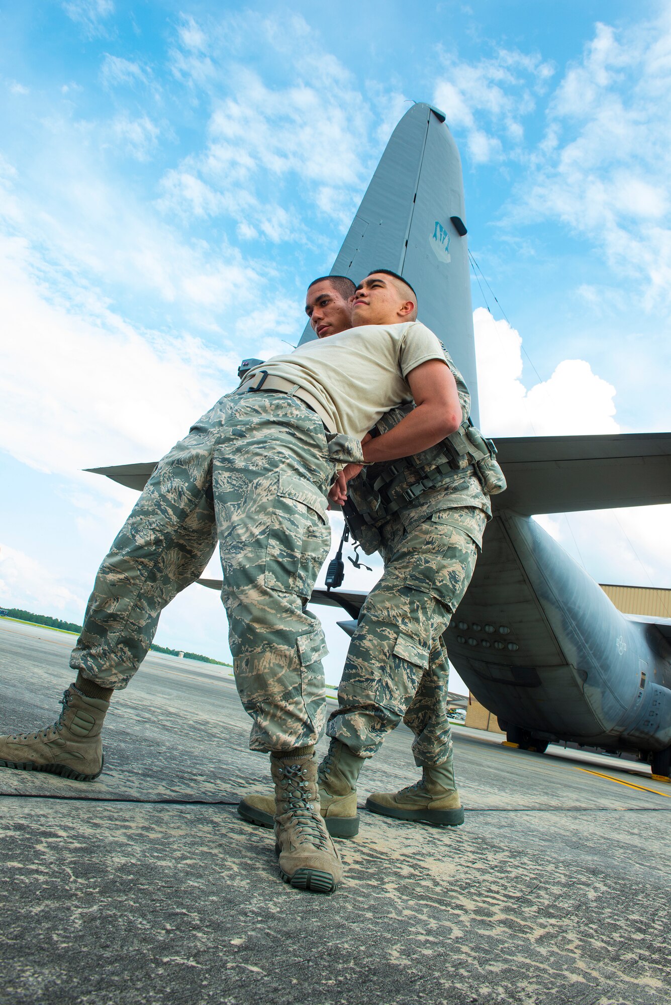 U.S. Air Force Airman 1st Class Aaron Gauding  searches Airman 1st Class Kanejoshua Smoot, both 23d Security Forces Squadron patrolmen, during a simulated training exercise at Moody Air Force Base, Ga., July 22, 2014.The 23d SFS uses this training exercise to readily spot unauthorized personnel on the flight line and remove them. (U.S. Air Force photo by Airman 1st Class Ceaira Tinsley/Released)