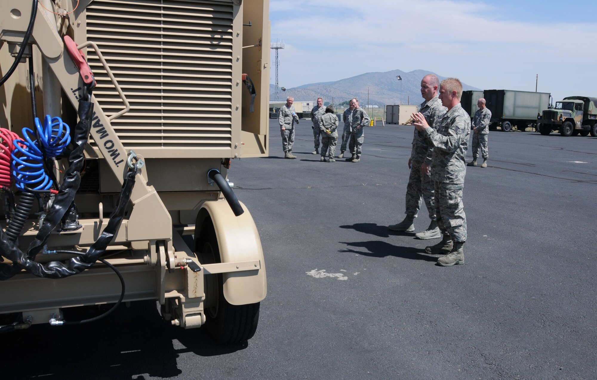 U.S. Air Force Staff Sgt. Mark Chinander, 270th Air Traffic Control Squadron, shows the Air National Guard Command Chief, James W. Hotaling, a new mobile Tactical Air Navigation system during Hotaling's visit to Kingsley Field, Klamath Falls, Ore. July 15, 2014. Hotaling spent the day meeting and speaking with the Airmen of the 173rd FW and 270th Air Traffic Control Squadron. (U.S. Air National Guard photo by Master Sgt. Jennifer Shirar/Released)