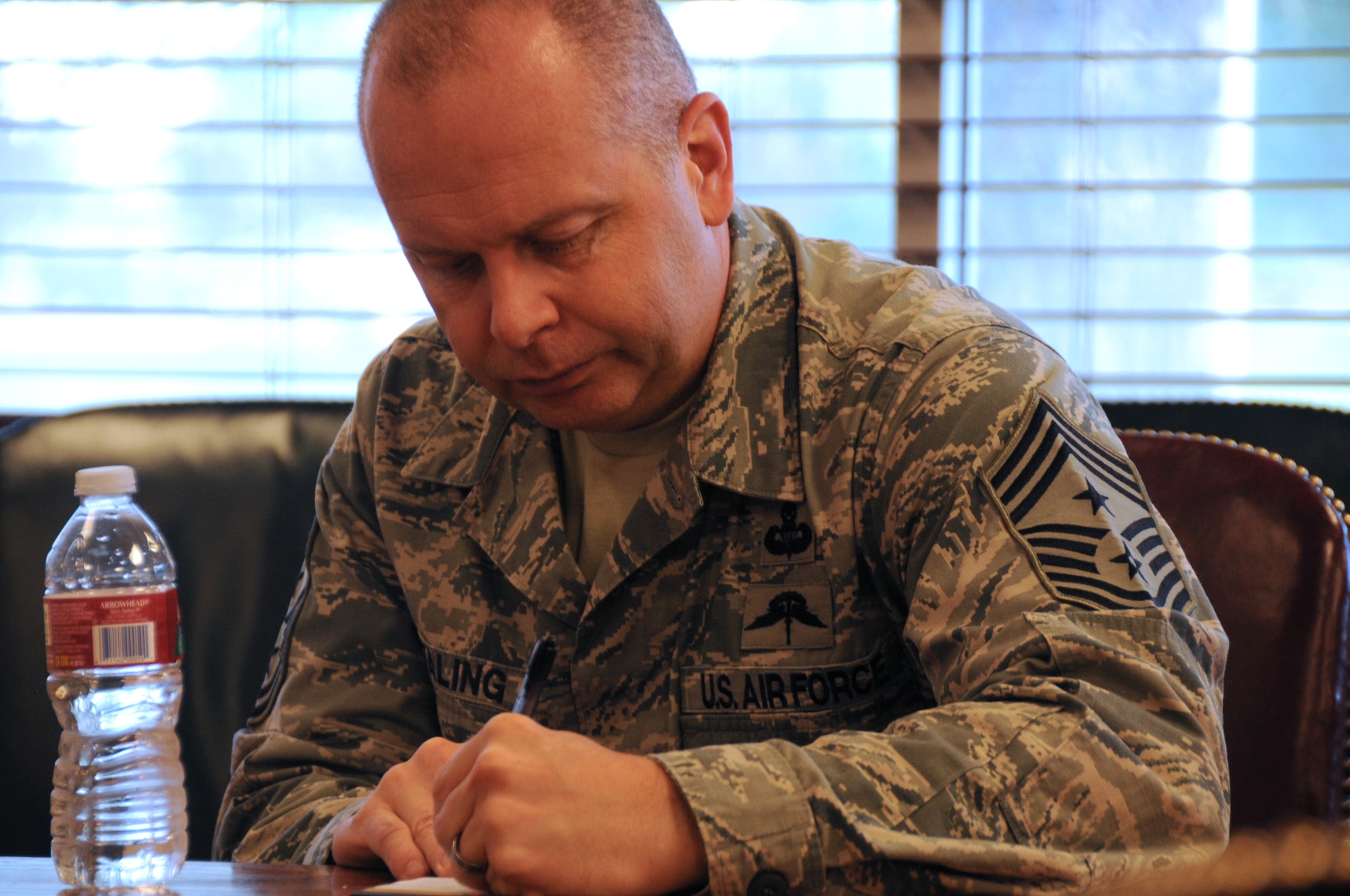 The Command Chief Master Sgt. of the Air National Guard, James W. Hotaling, takes notes during a meeting with the 173rd Fighter Wing Vice Commander, Col. Gregor Leist, during Hotaling's visit to Kingsley Field, Klamath Falls, Ore. July 15, 2014. Hotaling spent the day meeting and speaking with the Airmen of the 173rd FW and 270th Air Traffic Control Squadron. (U.S. Air National Guard photo by Master Sgt. Jennifer Shirar/Released)