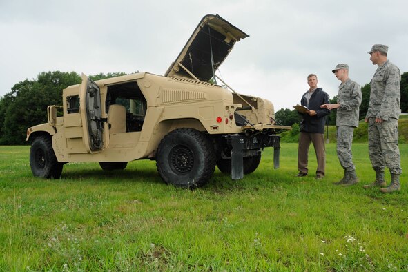 Don MacMillan (from left) and Air Force 1st Lts. Aaron Zadalis and Matt Cignoli, discuss the future installaltion of the Mobile Communications Sytem onto an M1145 Humvee at Hanscom Air Force Base, Mass., July 16, 2014. The Tactical Air Control Party-Modernization program office at Hanscom is responsible for integrating the communication system onto the TACP-specific Humvee. The MCS will allow joint terminal attack controllers to control close-air support aircraft from the safety of an armored vehicle. (U.S. Air Force photo/Linda LaBonte Britt) 

