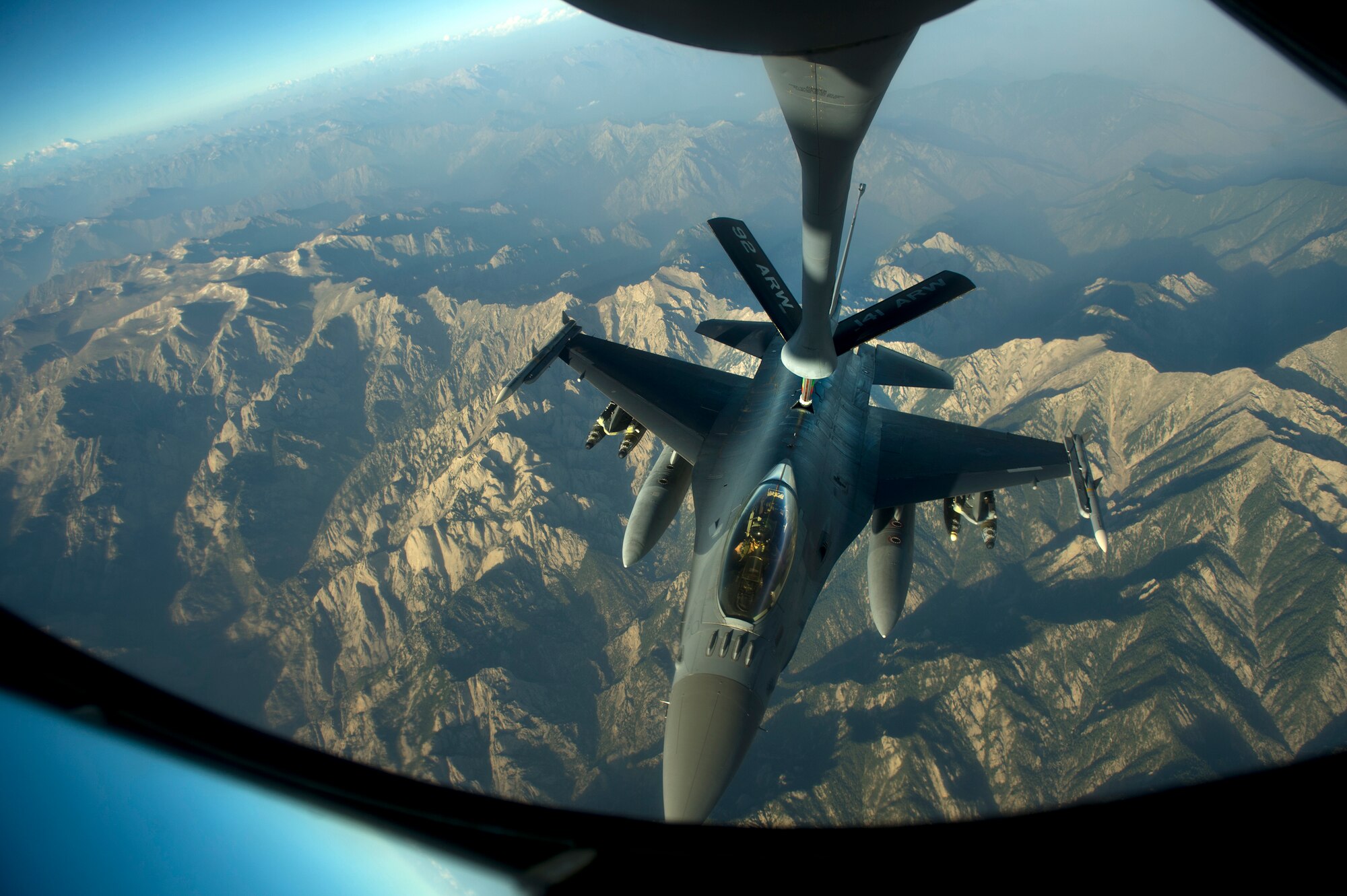 An F-16C Fighting Falcon receives fuel from a KC-135 Stratotanker during an in-air refueling mission over Afghanistan in support of Operation Enduring Freedom, July 22, 2014. The F-16 Fighting Falcon is a compact, multi-role fighter aircraft. It is highly maneuverable and has proven itself in air-to-air combat and air-to-surface attack. It provides a high-performance weapon system for the United States and allied nations. (U.S. Air Force photo by Staff Sgt. Vernon Young Jr. /Released)