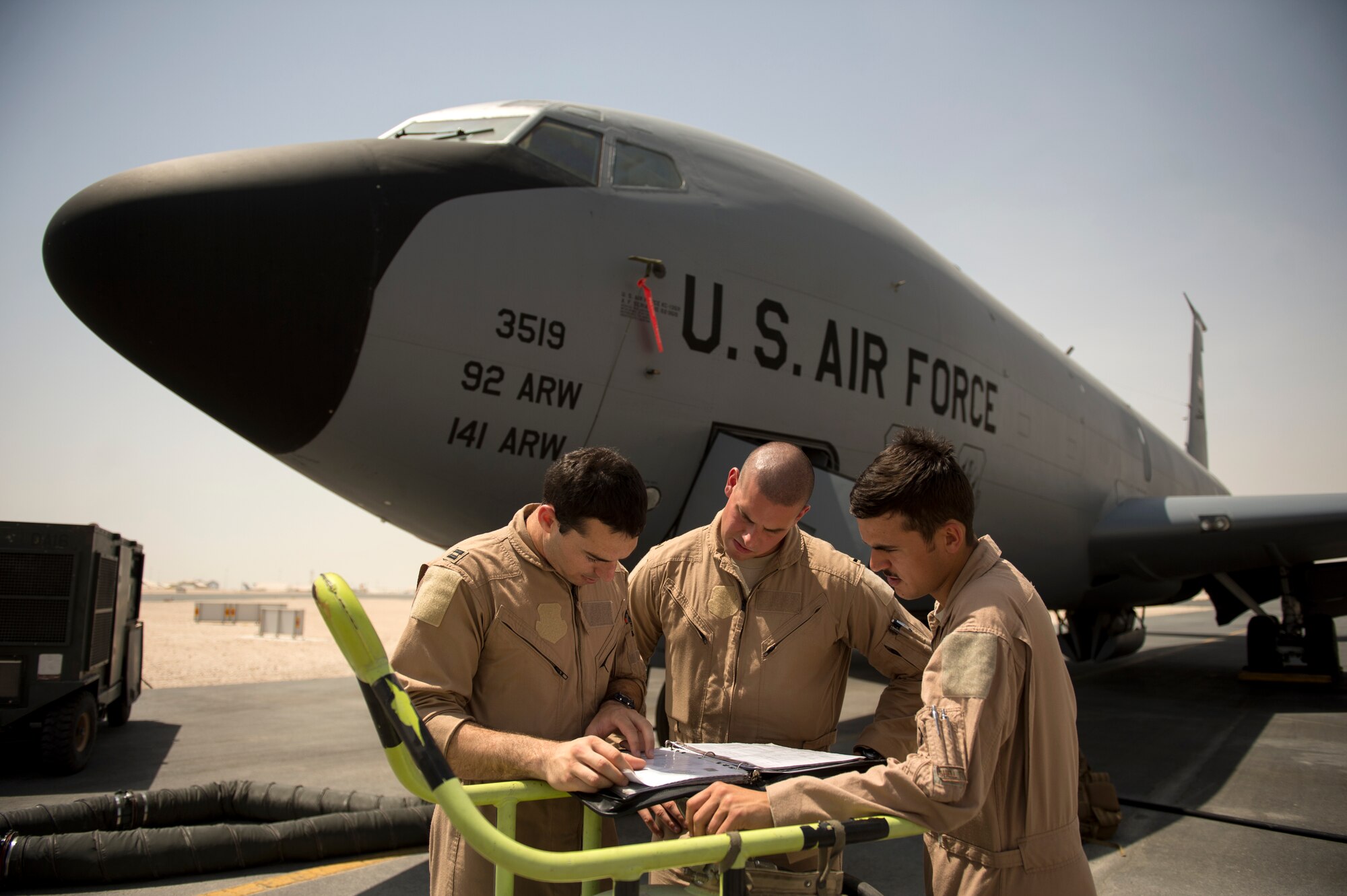 Capt. Christopher Carr, 1st Lt. Daniel Winningham and Airman 1st Class Jordan Gese, 340th Expeditionary Air Refueling Squadron KC-135 Stratotanker aircrew, reviews a pre-flight inspection prior to an in-air refueling mission over Afghanistan in support of Operation Enduring Freedom, July 22, 2014. The dedicated aircrew is deployed from the 93rd Aerial Refueling Squadron, Fairchild Air Force Base, Washington (U.S. Air Force photo by Staff Sgt. Vernon Young Jr./Released)