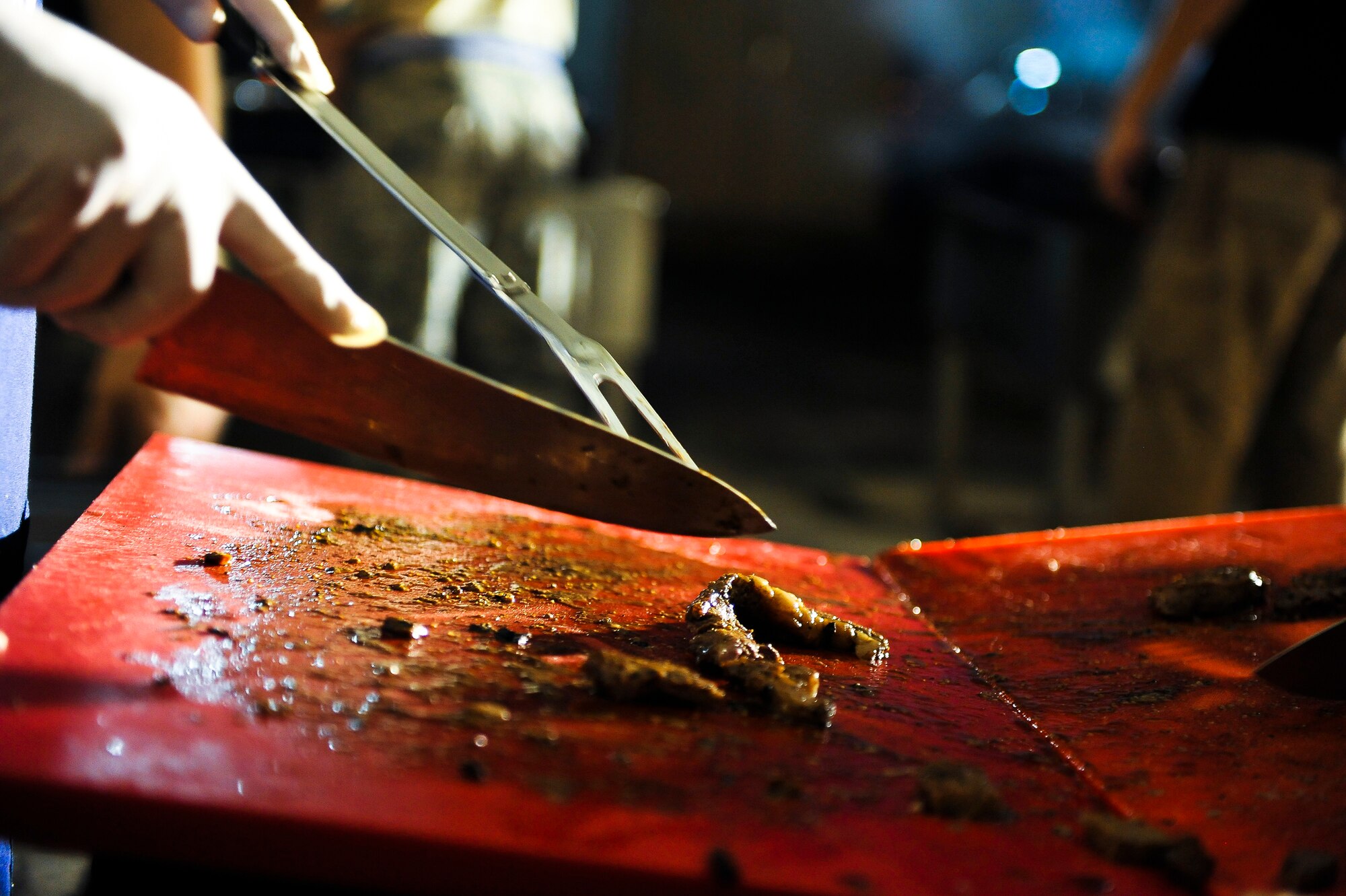 Members of the 380th First Sergeant’s Council prepare steaks for maintenance and operations workers July 20, 2014, at an undisclosed location in Southwest Asia. The barbeque is just one of many things the council does to connect with Airmen around the base. (U.S. Air Force photo by Tech. Sgt. Russ Scalf/Released)