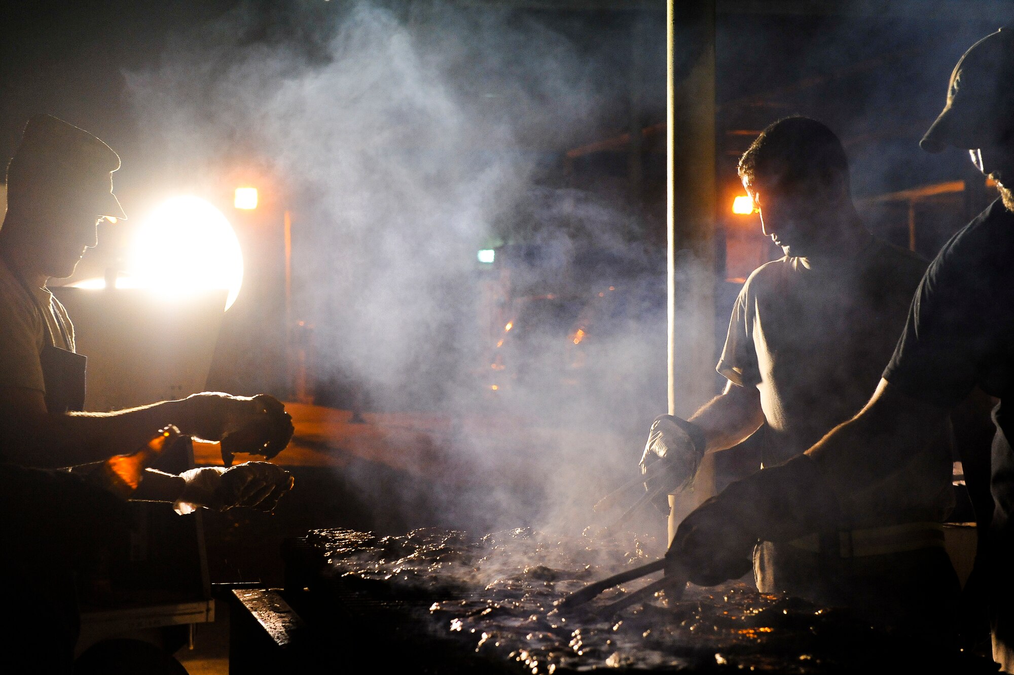 Members of the 380th First Sergeant’s Council prepare steaks for maintenance and operations workers July 20, 2014, at an undisclosed location in Southwest Asia. The barbeque is just one of many things the council does to connect with Airmen around the base. (U.S. Air Force photo by Tech. Sgt. Russ Scalf/Released)