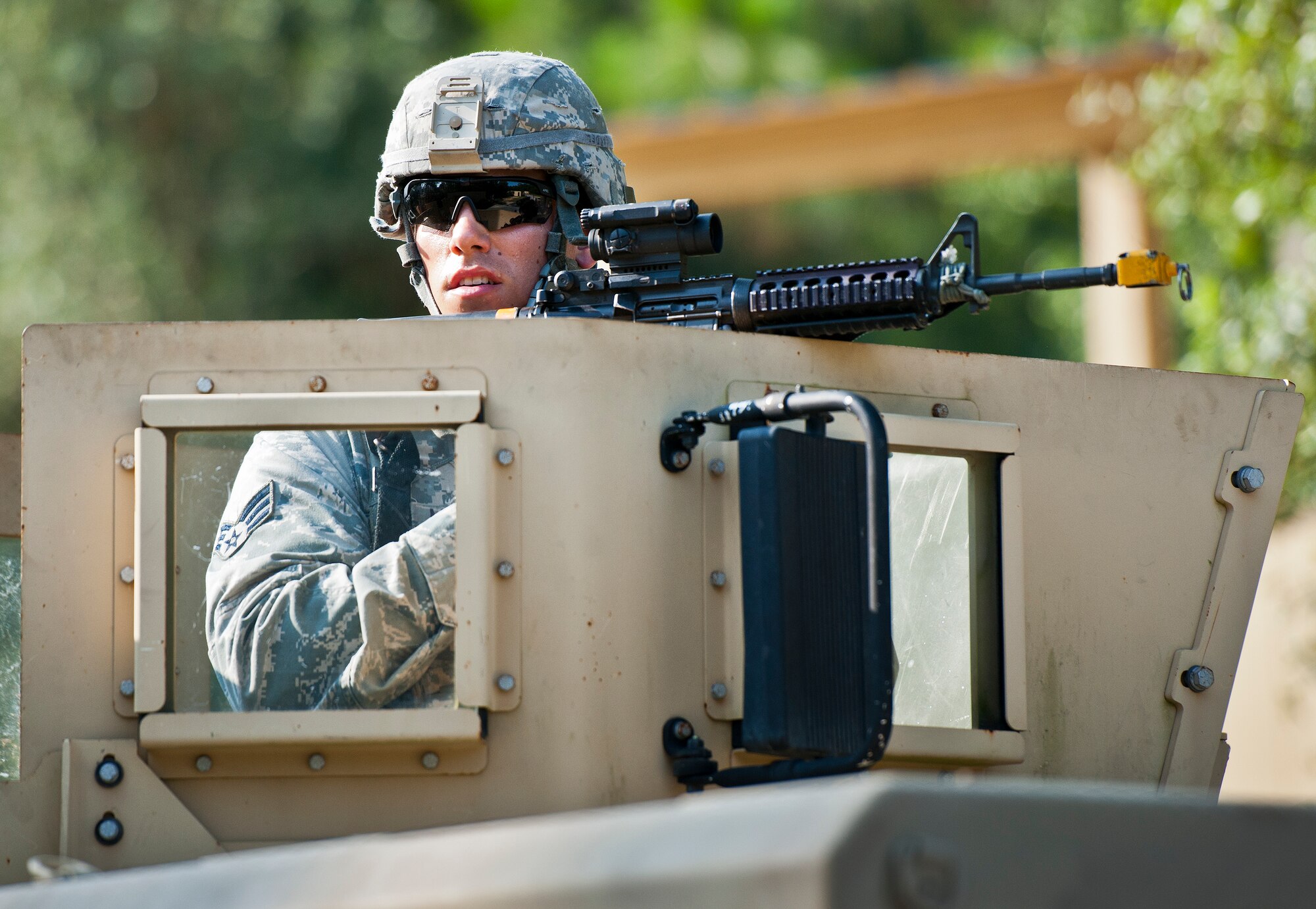 A Security forces Airman stands watch from the turret seat of a armored Humvee during a village raid at the conclusion of their three-day field training exercise at Eglin Air Force Base, Fla., July 22.  The exercise is the culmination of the base’s last six-week security forces deployment training course known as Brave Defender and administered by the 96th Ground Combat Training Squadron.  The squadron will be officially deactivated Oct. 1 and the mission will move to Fort Bliss, Texas.  (U.S. Air Force photo/Samuel King Jr.)