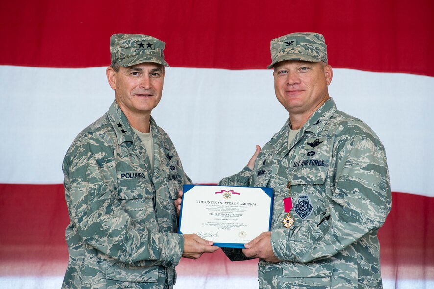 U.S. Air Force Maj. Gen. H.D. Polumbo Jr., left, Ninth Air Force commander, and Col. Samuel Milam, outgoing 93d Air Ground Operations Wing commander, pose for a photo during a change of command ceremony at Moody Air Force Base, Ga., July 23, 2014. Polumbo awarded Milam the Legion of Merit  for his leadership while in command. (U.S. Air Force photo by Airman 1st Class Ryan Callaghan/Released)