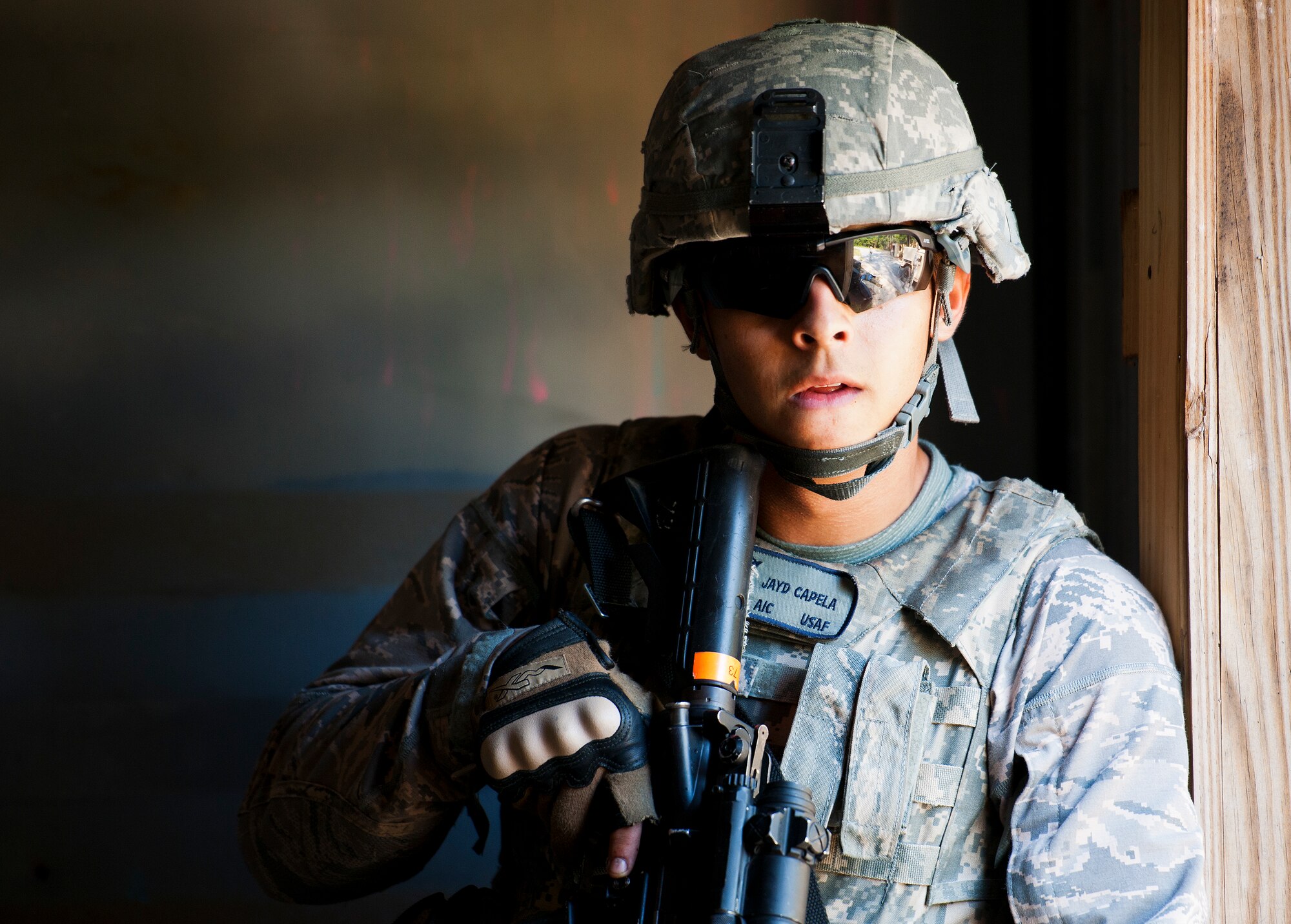 Airman 1st Class Jayd Capela, with the 824th Base Defense Squadron, waits for back up to secure a building during a village raid at the conclusion of their three-day field training exercise at Eglin Air Force Base, Fla., July 22.  The exercise is the culmination of the base’s last six-week security forces deployment training course known as Brave Defender and administered by the 96th Ground Combat Training Squadron.  The squadron will be officially deactivated Oct. 1 and the mission will move to Fort Bliss, Texas.  (U.S. Air Force photo/Samuel King Jr.)