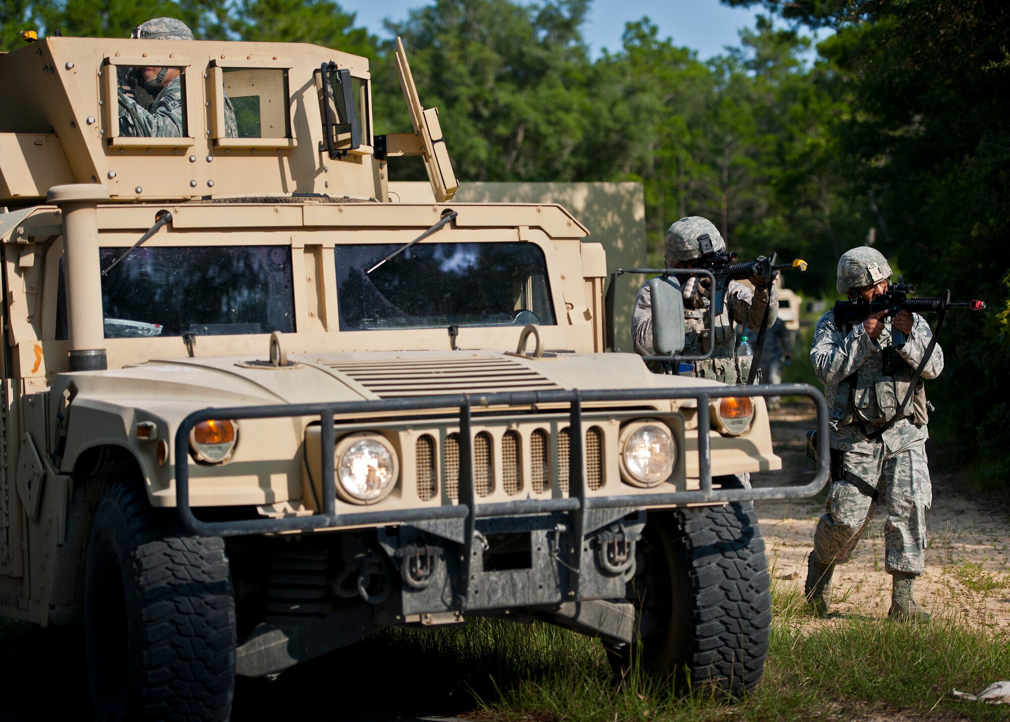 Security forces Airmen move up through a village with the help of an armored Humvee during a raid at the conclusion of their three-day field training exercise at Eglin Air Force Base, Fla., July 22.  The exercise is the culmination of the base’s last six-week security forces deployment training course known as Brave Defender and administered by the 96th Ground Combat Training Squadron.  The squadron will be officially deactivated Oct. 1 and the mission will move to Fort Bliss, Texas.  (U.S. Air Force photo/Samuel King Jr.)