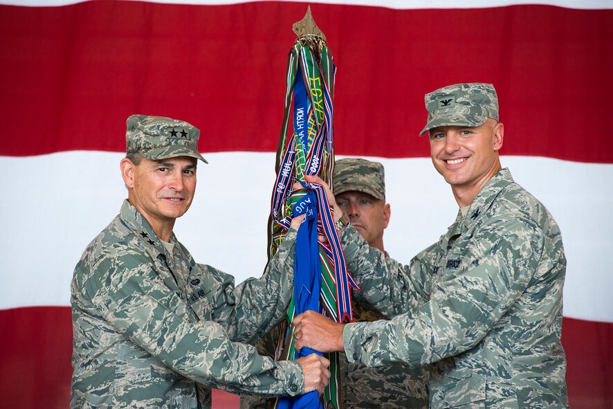 U.S. Air Force Maj. Gen. H.D. Polumbo Jr., left, Ninth Air Force commander, and Col. Joseph Locke, 93d Air Ground Operations Wing incoming commander, pose for a photo during a change of command ceremony at Moody Air Force Base, Ga., July 23, 2014. The passing of the guidon signifies the assumption of command by the incoming commander. (U.S. Air Force photo by Airman 1st Class Ryan Callaghan/Released)