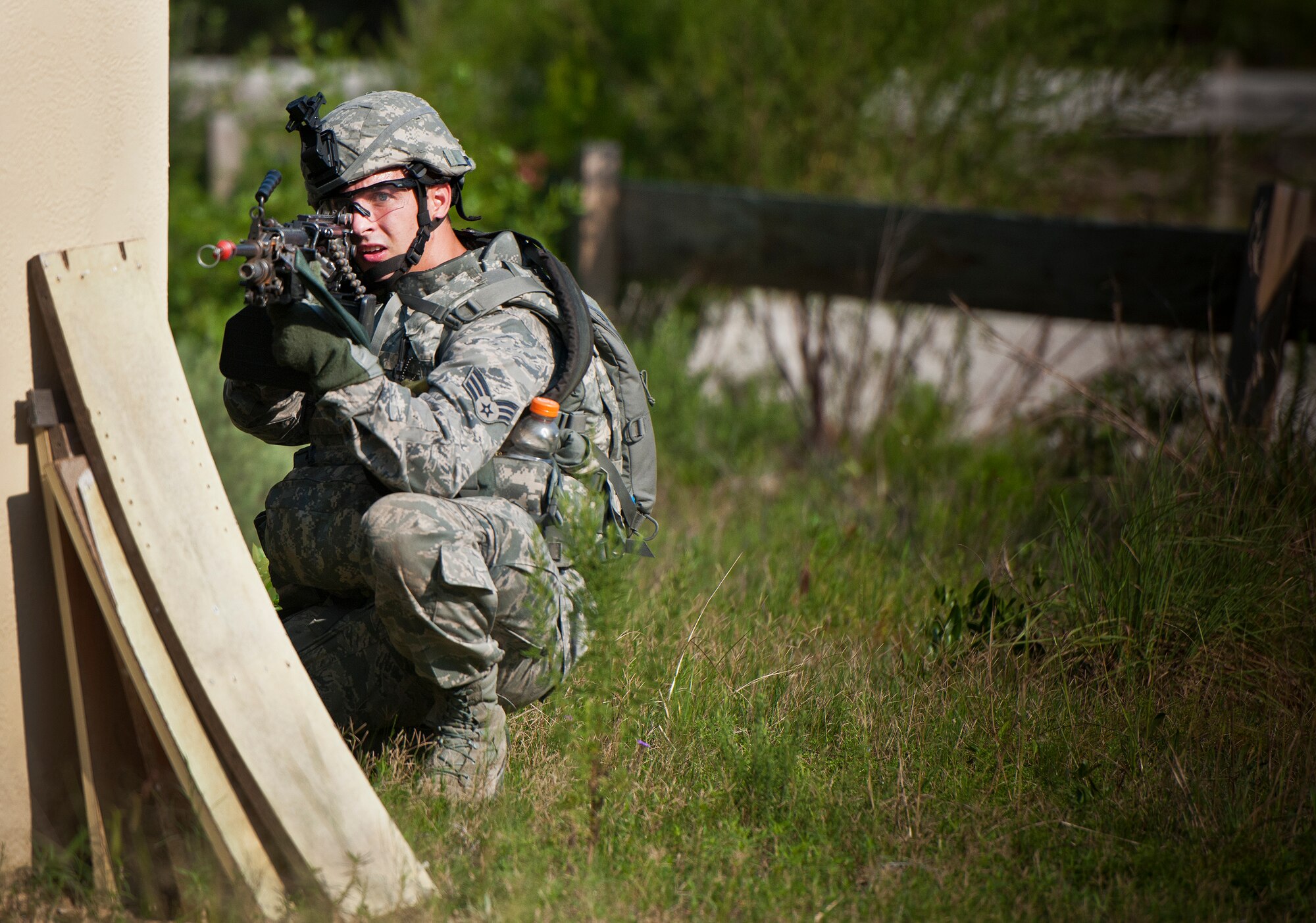 A Security forces Airman points his weapon down range during a village raid at the conclusion of their three-day field training exercise at Eglin Air Force Base, Fla., July 22.  The exercise is the culmination of the base’s last six-week security forces deployment training course known as Brave Defender and administered by the 96th Ground Combat Training Squadron.  The squadron will be officially deactivated Oct. 1 and the mission will move to Fort Bliss, Texas.  (U.S. Air Force photo/Samuel King Jr.)