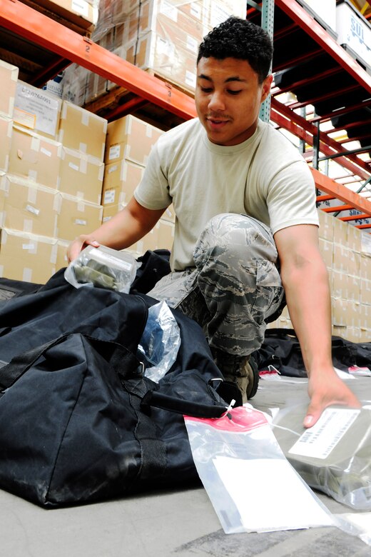 Senior Airman Jordan Wright, 39th Logistics Readiness Squadron material management journeyman, builds a “C” bag at the mobility bag warehouse July 22, 2014, Incirlik Air Base, Turkey. A “C” bag contains a variety of individual protective equipment. (U.S. Air Force photo by Staff Sgt. Eboni Reams/Released) 