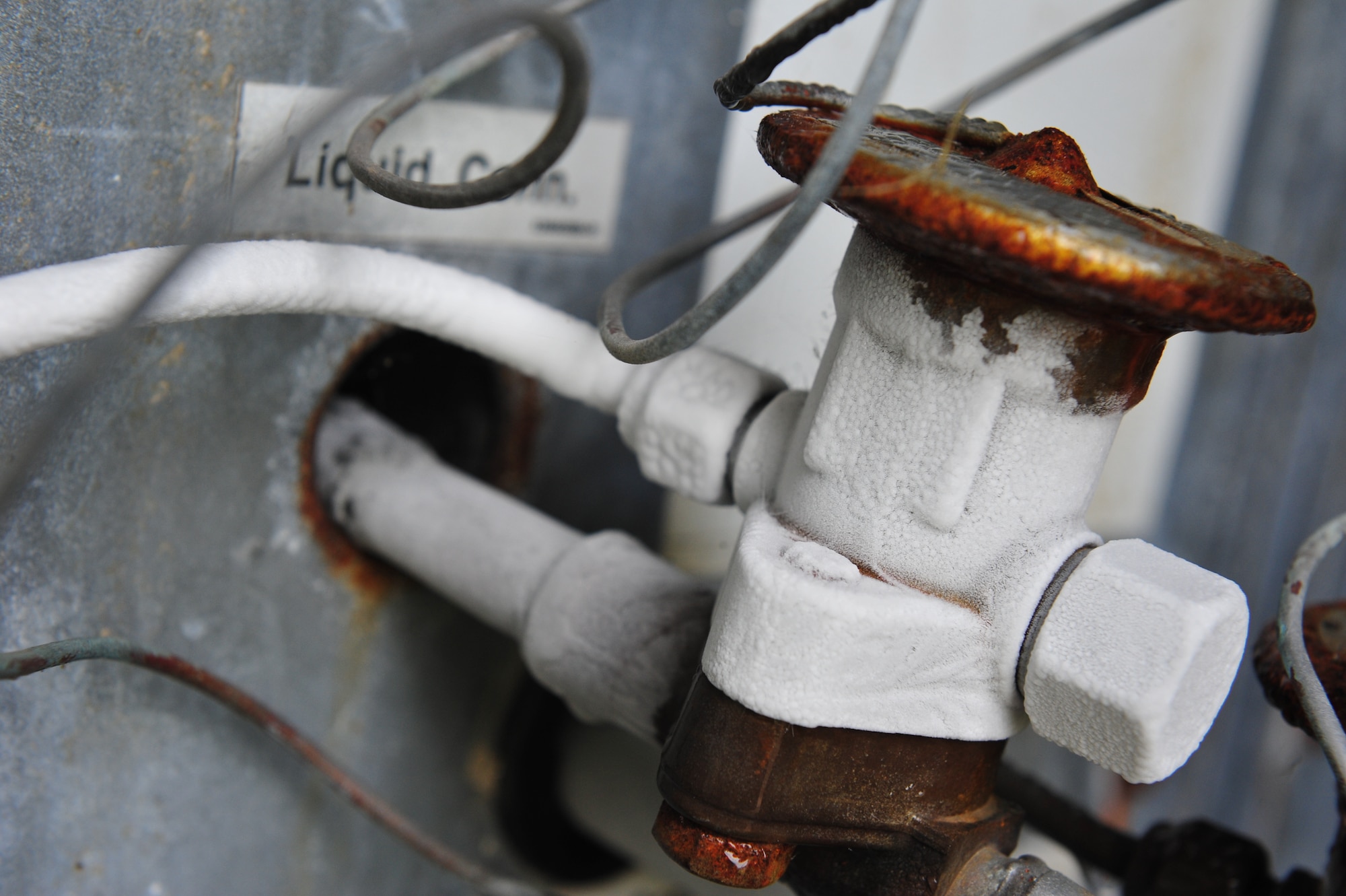 Despite the outdoor temperatures, the lines on a condenser unit begin to freeze and alert 8th Civil Engineer Squadron Heating, Ventilation, Air Conditioning and Refrigeration shop technicians to an issue with the unit at Kunsan Air Base, Republic of Korea, July 23, 2014. Pressure checks were done on the unit revealing it was low on refrigerant and needed recharging. (U.S. Air Force photo by 1st Lt. Earon Brown/Released)