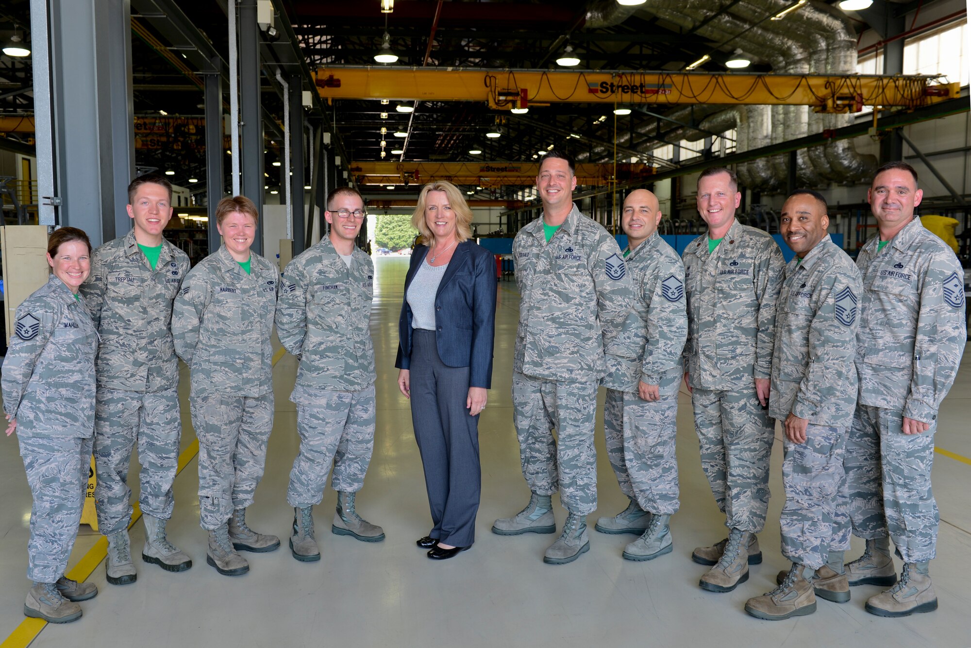 Secretary of the Air Force Deborah Lee James, center, pauses for a group photo during her visit to the propulsion shop at Royal Air Force Lakenheath, England, July 18, 2014. James visited numerous squadrons to interact with Airmen and learn more about the 48th Fighter Wing’s mission. Liberty Wing Airmen wear colored squadron t-shirts every Friday. (U.S. Air Force photo by Airman 1st Class Trevor T. McBride/Released)