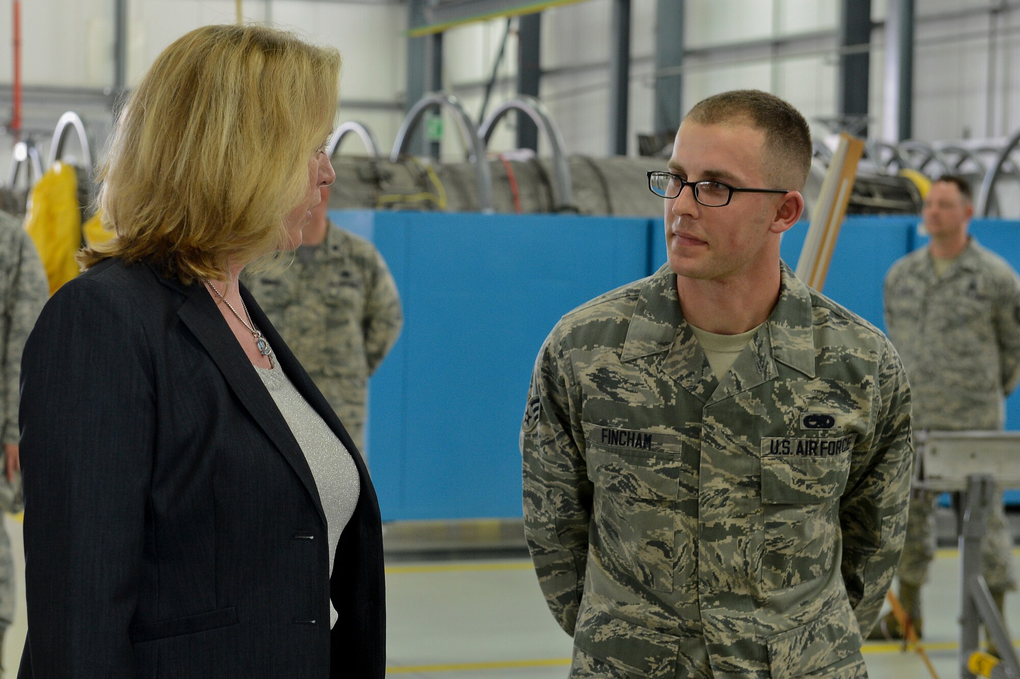 Senior Airman Cory Fincham, 48th Component Maintenance Squadron aerospace propulsion journeyman, speaks with Secretary of the Air Force Deborah Lee James during her visit to the propulsion shop at Royal Air Force Lakenheath, England, July 18, 2014. James visited numerous squadrons to interact with Airmen and learn more about the 48th Fighter Wing’s mission. (U.S. Air Force photo by Airman 1st Class Trevor T. McBride/Released)