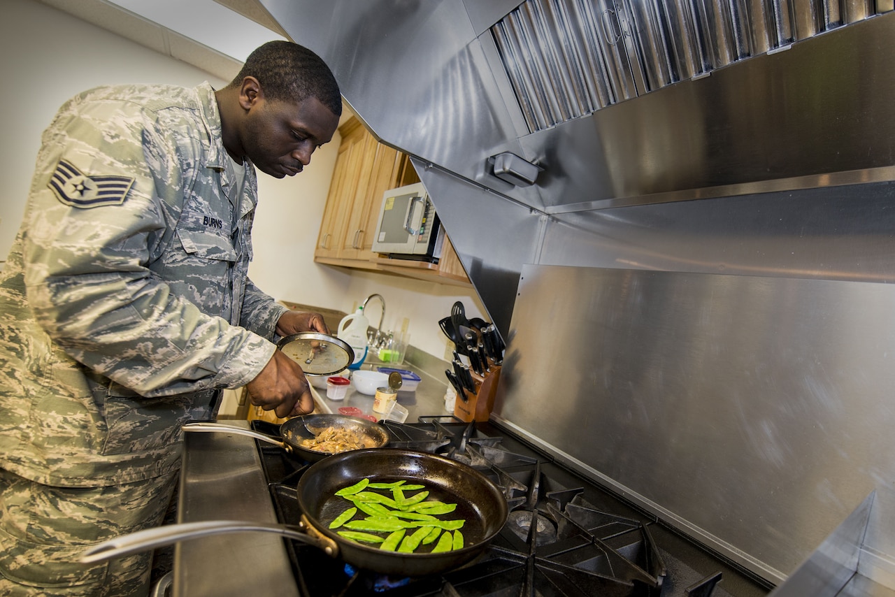 Air Force Staff Sgt. Phillip Burns II prepares Monterey chicken July 17, 2014, on Moody Air Force Base, Ga. Burns garnished his plate with sweet peas and mushroom sauce. He is a 23rd Civil Engineer Squadron fire inspector. U.S. Air Force photo by Airman 1st Class Ryan Callaghan
