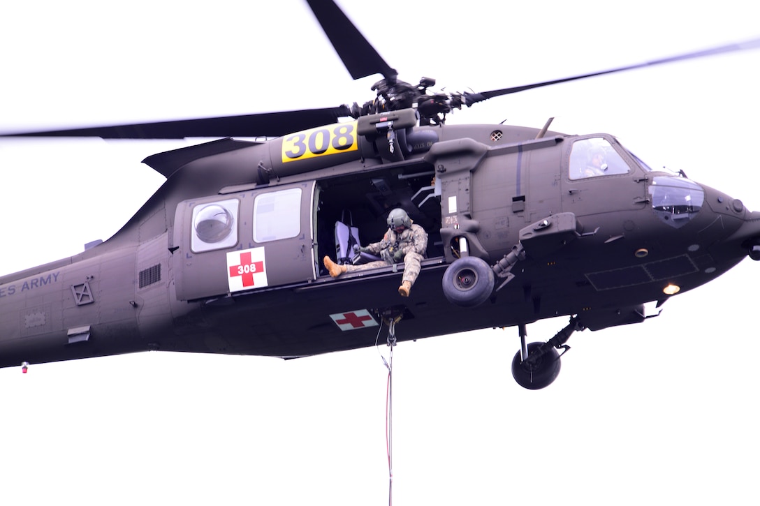 Army Sgt. 1st Class Mark Carter operates the Bambi bucket from an HH-60M Black Hawk helicopter during efforts to fight the Logging Unit fire west of Madras, Ore., July 21, 2014. Carter is assigned to the Oregon Army National Guard's Company C, 1st Battalion, 168th Aviation Regiment. 