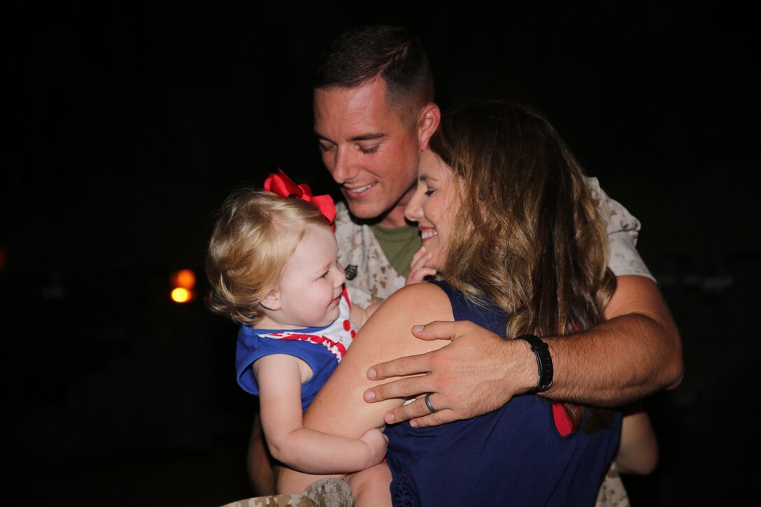 Staff Sergeant David Gentry embraces his wife, Megan, and his 15-month-old daughter after returning to Marine Corps Air Station Cherry Point July 24, 2014, from a four-month deployment to Morón Air Base, Spain, in support of Special Purpose Marine Air-Ground Task Force Crisis Response. Gentry was the detachment staff non-commissioned officer in charge with Marine Wing Support Squadron 271.


