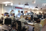 Personnel in the Alaska National Guard's Joint Operation Center work to resource a request from the State Emergency Operation Center to send more than 50 Guard members, supplies and equipment to Cordova on Jan. 7, 2012.