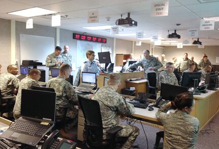 Personnel in the Alaska National Guard's Joint Operation Center work to resource a request from the State Emergency Operation Center to send more than 50 Guard members, supplies and equipment to Cordova on Jan. 7, 2012.