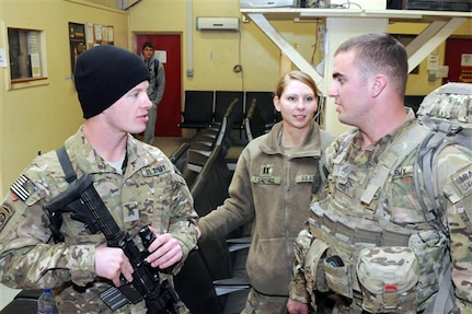 Army Sgt. Nicholaus A. Hale, left, Army Capt. Rikki Salyers and Army Sgt. Adam M. Hale talk to a public affairs official on Forward Operating Base Salerno, Afghanistan, Jan. 6, 2012. The three siblings reunited after four years with help from Army Maj. Gen. Daniel Allyn, Regional Command East commander, after the general received an email from their father.