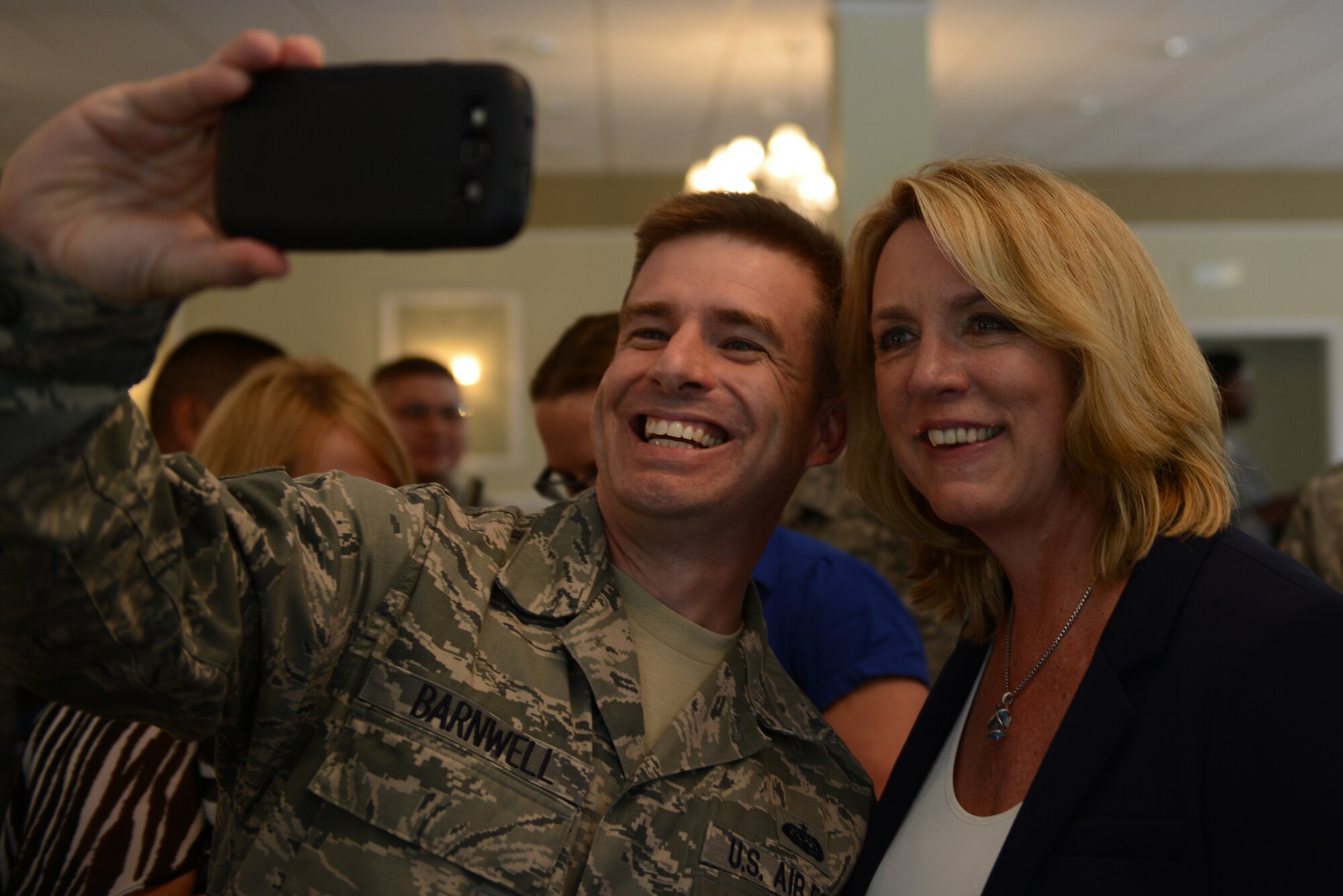 Secretary of the Air Force Deborah Lee James takes a selfie with Tech. Sgt. Michael Barnwell July 17, 2014, at Royal Air Force Alconbury, England. James visited RAF Molesworth and RAF Alconbury two of seven 501st Combat Support Wing installations, and learned about the wing’s mission directly from the Airmen who drive it. Barnwell is from the 422nd Communications Squadron. (U.S. Air Force photo/Tech. Sgt. Chrissy Best)