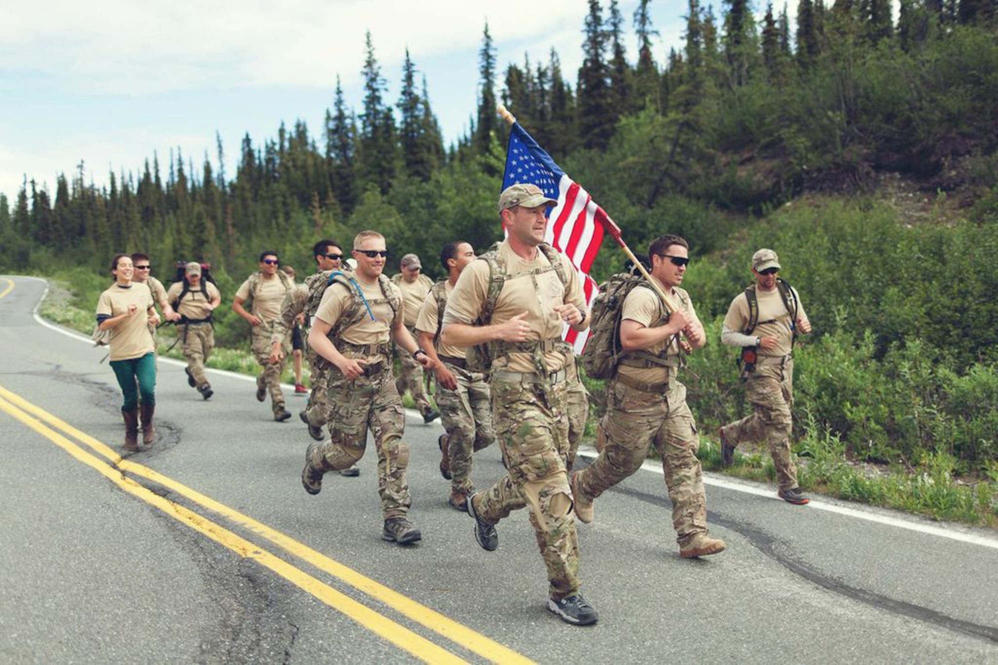 Tactical air control party Airmen with the 3rd Air Support Operations Squadron at Fort Wainwright and Joint Base Elmendorf-Richardson, Alaska, ruck along the Denali Highway July 14-18, 2014, between Paxson and Cantwell, Alaska. The Airmen raised over $5,000 for the TACP Association and rucked a total of 275 miles in remembrance of fallen comrades. (Courtesy photo/Senior Airman Stephan Phan)