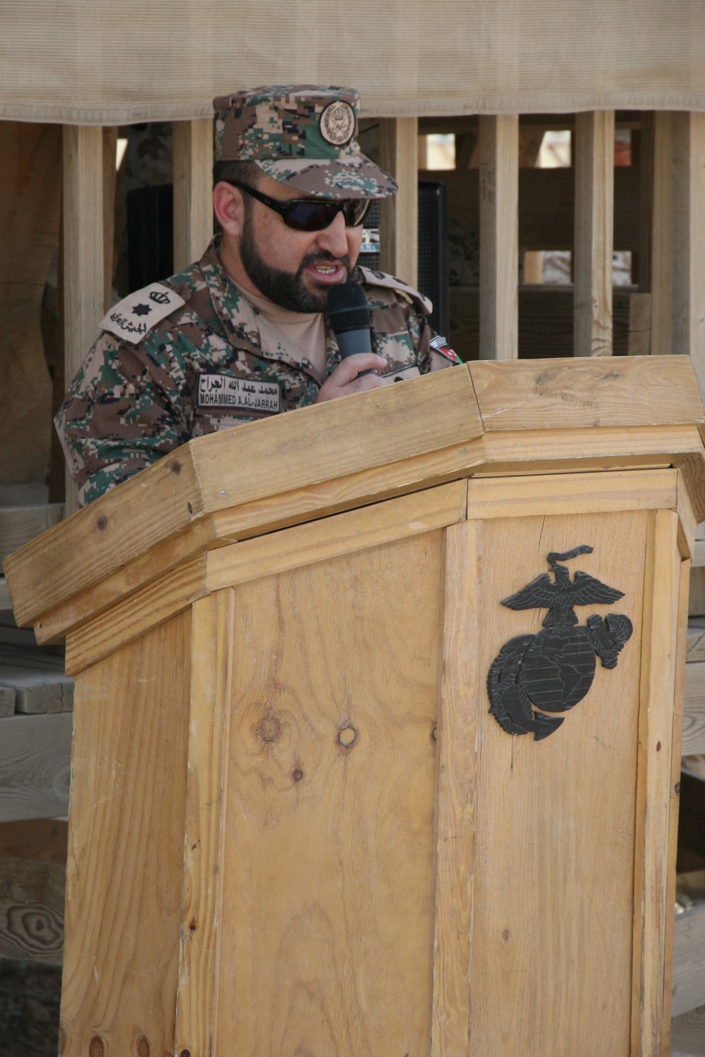 Lt. Col. Mohammed A. Aljarrah, commanding officer of the Jordanian Army with Regional Command (Southwest), addresses service members during the Jordanian flag-lowering ceremony aboard Camp Leatherneck, Helmand province, Afghanistan, July 23, 2014. The ceremony marked the end of mission for the Kingdom of Jordan's army serving with RC(SW).