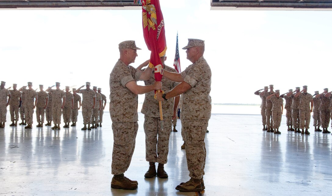 MACDILL AIR FORCE BASE, Fla. – Lt. Gen. Kenneth McKenzie (left), began his tenure as commander of U.S. Marine Corps Forces Central Command when he received the unit colors from his predecessor Lt. Gen. Robert Neller during a change of command ceremony here, June 18. (USCENTCOM photo by Sgt. Fredrick J Coleman, USMC)