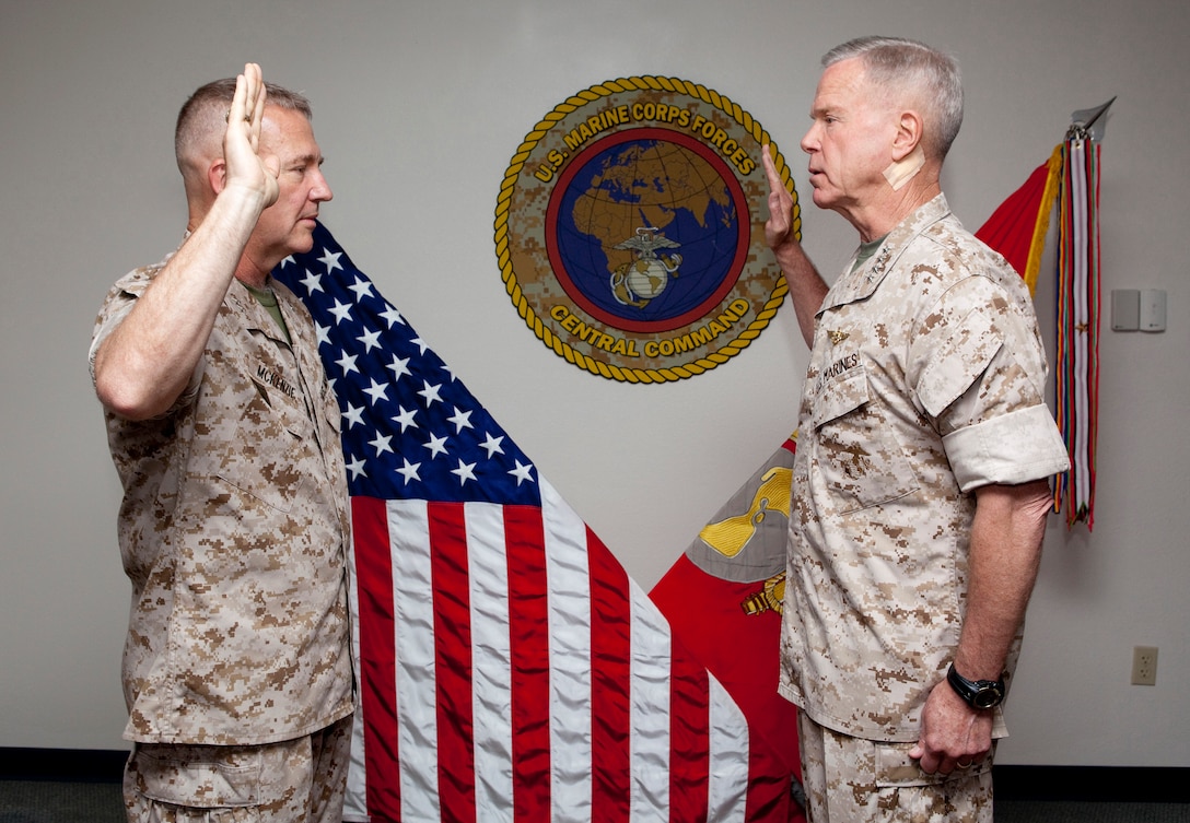 MACDILL AIR FORCE BASE, Fla. – Gen. John Amos, Commandant of the Marine Corps, administered the Officer Oath of Office to Lt. Gen. Kenneth McKenzie during his promotion ceremony here, June 18.  McKenzie later assume command of U.S. Marine Corps Forces Central Command during a change of command ceremony. (USCENTCOM photo by Sgt. Fredrick J Coleman, USMC)