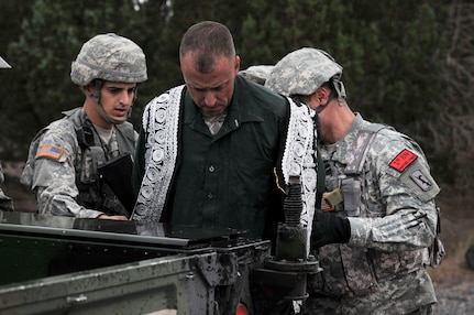 Army Sgt. Andrew Black, left, from the California Army National Guard's D Company, 578th Brigade Engineer Battalion, and Army Sgt. Valdimir Kuvshinov, with the California Army Guard's B Company, 250th Military Intelligence Battalion, detain a fellow Soldier playing the role of a high-value individual in an information gathering exercise during training exercise Panther Strike 2014 at Camp Williams, Utah. The 578th BEB is the first brigade engineer battalion to be activated in the Army National Guard and part of an Army-wide change to provide greater organic engineer support to brigade combat teams. The BEB also contains signal, military intelligence and other non-engineer assets that provide BCT commanders a with a wide spectrum of capabilities on the battlefield. 