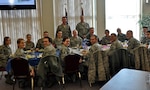 Command Chief Master Sgt. Christopher E. Muncy, command chief of the Air National Guard, prepares to eat lunch and talk with 15 members of the 128th Air Refueling Wing's enlisted Airmen in Milwaukee on January 8, 2012. Muncy was at the 128 ARW as part of a tour of all the Air National Guard bases located in Wisconsin.