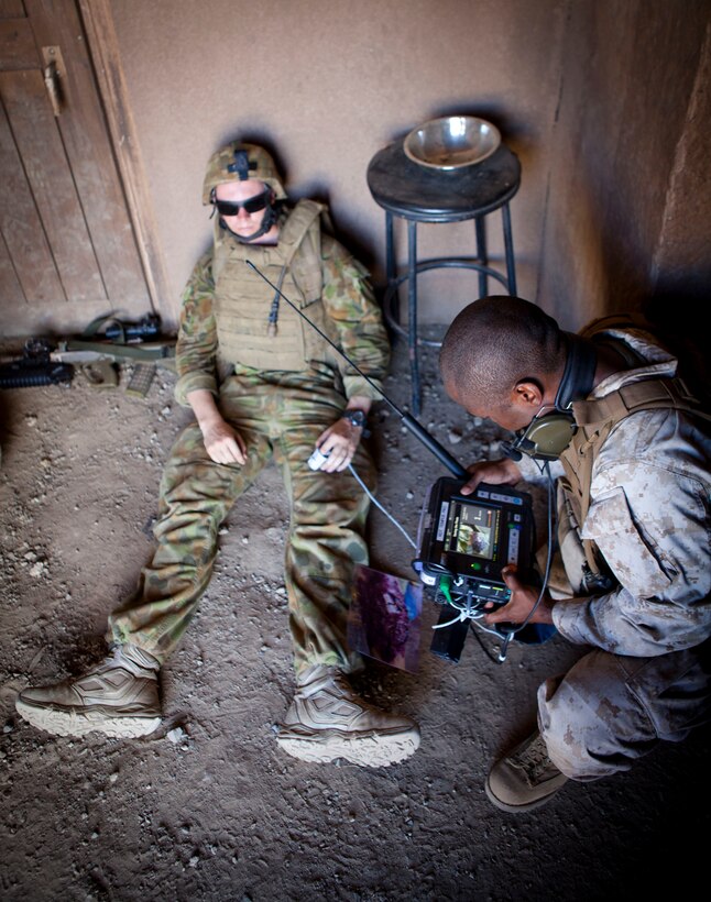 MARINE CORPS TRAINING AREA BELLOWS - The Remote Diagnostic Technology Tempus Pro, a highly integrated vital signs monitor widely used in aviation, maritime, exploration and military environments by medically and non-medically trained users, is being tested on a soldier with the Royal Australian Regiment during the 2014 Rim of the Pacific exercise at a military operations in urban terrain facility. Twenty-two nations, more than 40 ships and submarines, about 200 aircraft and 25,000 personnel are participating in RIMPAC from June 26 through Aug. 1 in and around the Hawaiian Islands and Southern California. The world's largest international maritime exercise, RIMPAC provides a unique training opportunity that helps participants foster and sustain the cooperative relationships that are critical to ensuring the safety of sea lanes and security on the world's oceans. RIMPAC 2014 is the 24th exercise in the series that began in 1971. (U.S. Marine Corps photo by Lance Cpl. Aaron S. Patterson)