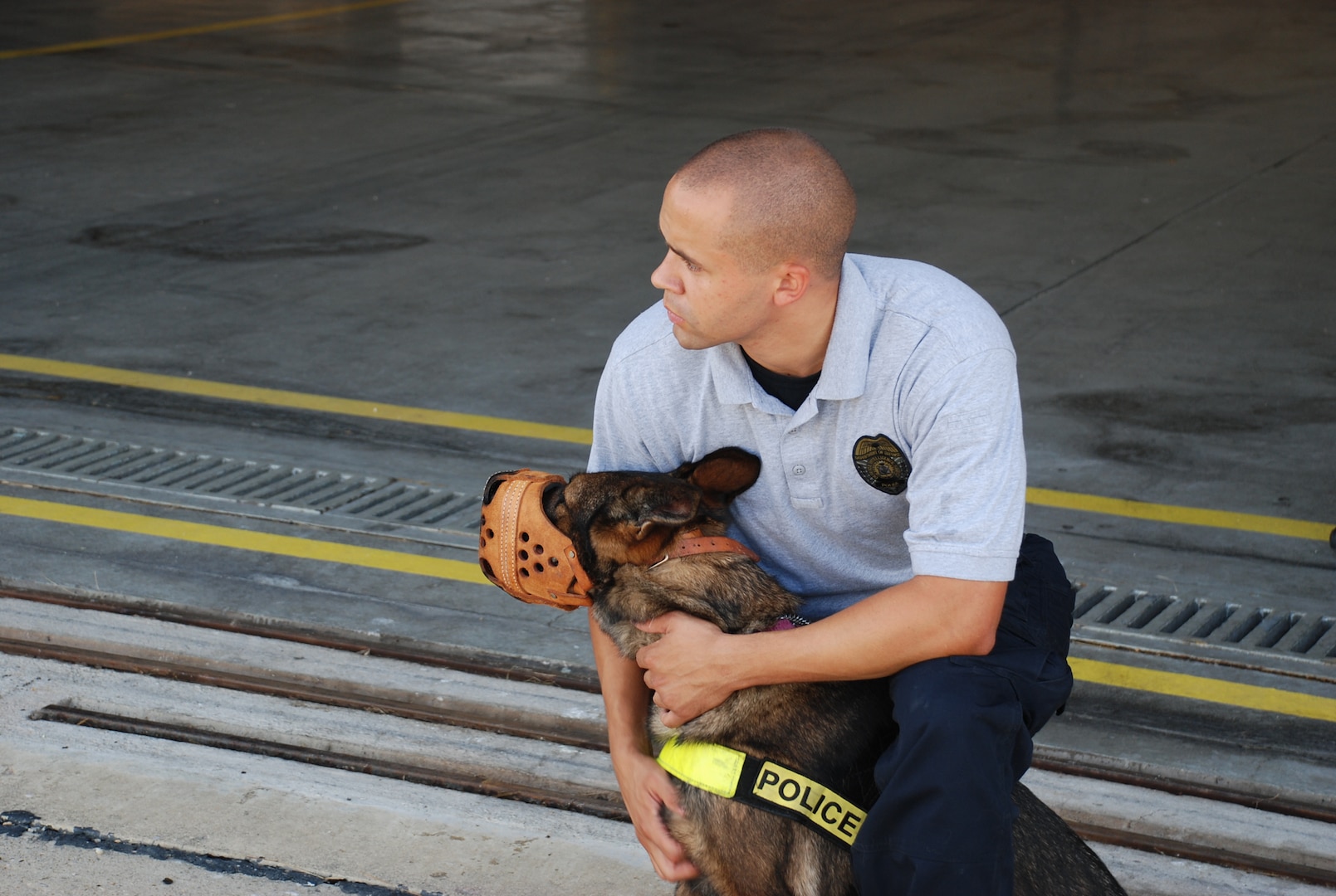 A DIA K-9 police officer and his dog, Dolly, wait to board the helicopters. 