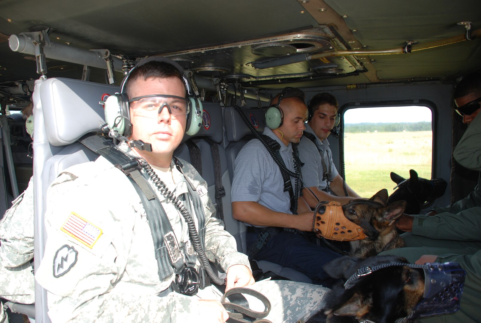 Members from the DIA K-9 police unit and Army 12th Aviation Brigade secure themselves and their dogs. 