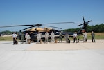 Members of the DIA K-9 police unit and the 12th Aviation Brigade stand together after a successful day of training. 