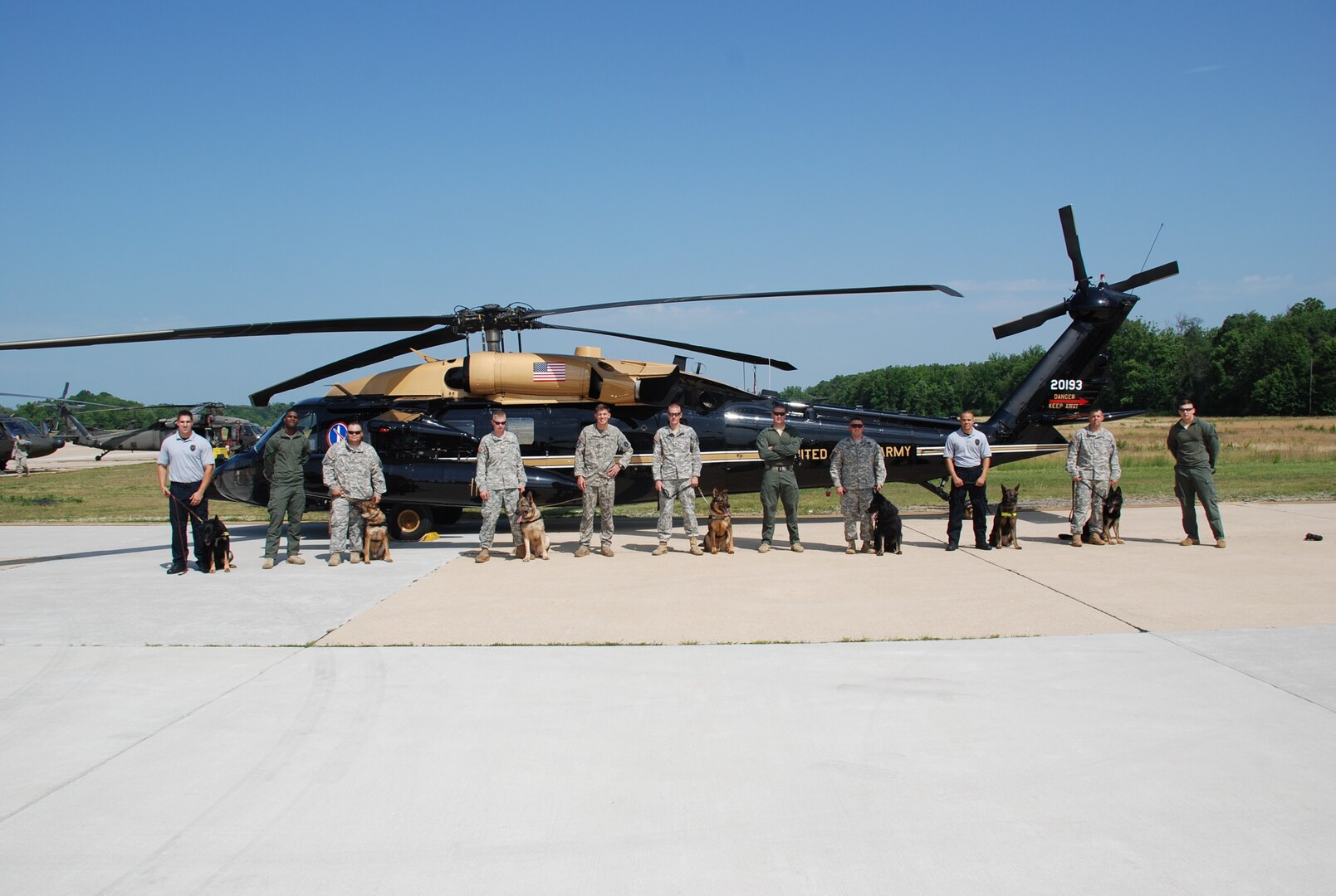 Members of the DIA K-9 police unit and the 12th Aviation Brigade stand together after a successful day of training. 