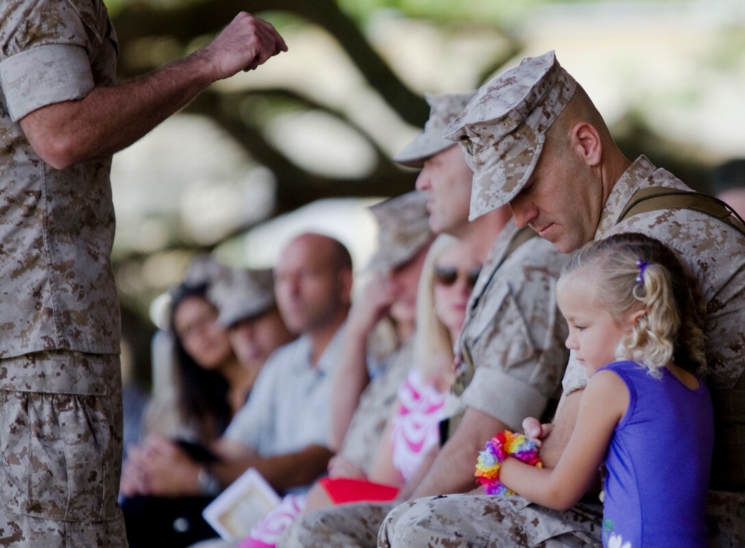 MARINE CORPS BASE HAWAII — Hope Coyne, hugs her father, Lt. Col. Brian P. Coyne, incoming commanding officer, 2nd Battalion, 3rd Marine Regiment, during a change of command ceremony at Dewey Square, July 18, 2014. Lt. Col. James B. Conway, outgoing commanding officer, relinquished command of 2nd Battalion, 3rd Marine Regiment to Coyne during the ceremony. Coyne previously served as executive officer to the chief of staff at U.S. Special Operations Command in Tampa, Fla. Conway has led the “Island Warriors” since Feb. 5, 2013. (U.S. Marine Corps photo by Kristen Wong)