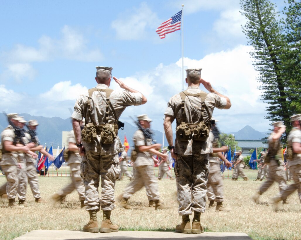 MARINE CORPS BASE HAWAII - Lt. Col. James B. Conway (left), outgoing commanding officer, and Lt. Col. Brian P. Coyne, incoming commanding officer, 2nd Battalion, 3rd Marine Regiment, render salutes during the pass in review portion of their change of command ceremony at Dewey Square, July 18, 2014. (U.S. Marine Corps photo by Kristen Wong)