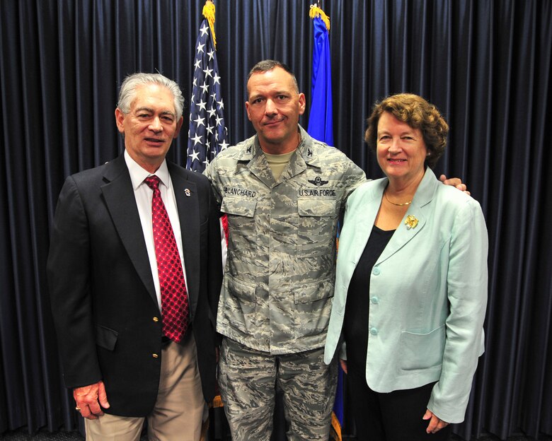 Mr. Mike Grassinger, Principle of The Planning Center and former D-M 50 President, U.S. Air Force Col. Kevin E. Blanchard, 355th Fighter Wing commander, and Ms. Shirley Scott, Ward 4 Tucson city council member, pose for a photo during a "Community Wingman” induction ceremony at Davis-Monthan Air Force Base, Ariz., July 24, 2014.  The Davis-Monthan Community Wingman program recognizes Tucson community leaders who have given tremendous support to our Airmen and many D-M missions.  Induction as a D-M Community Wingman solidifies the strong bond this city has with its local Airmen.  (U.S. Air Force Photo by Airman 1st Class Chris Massey/Released)