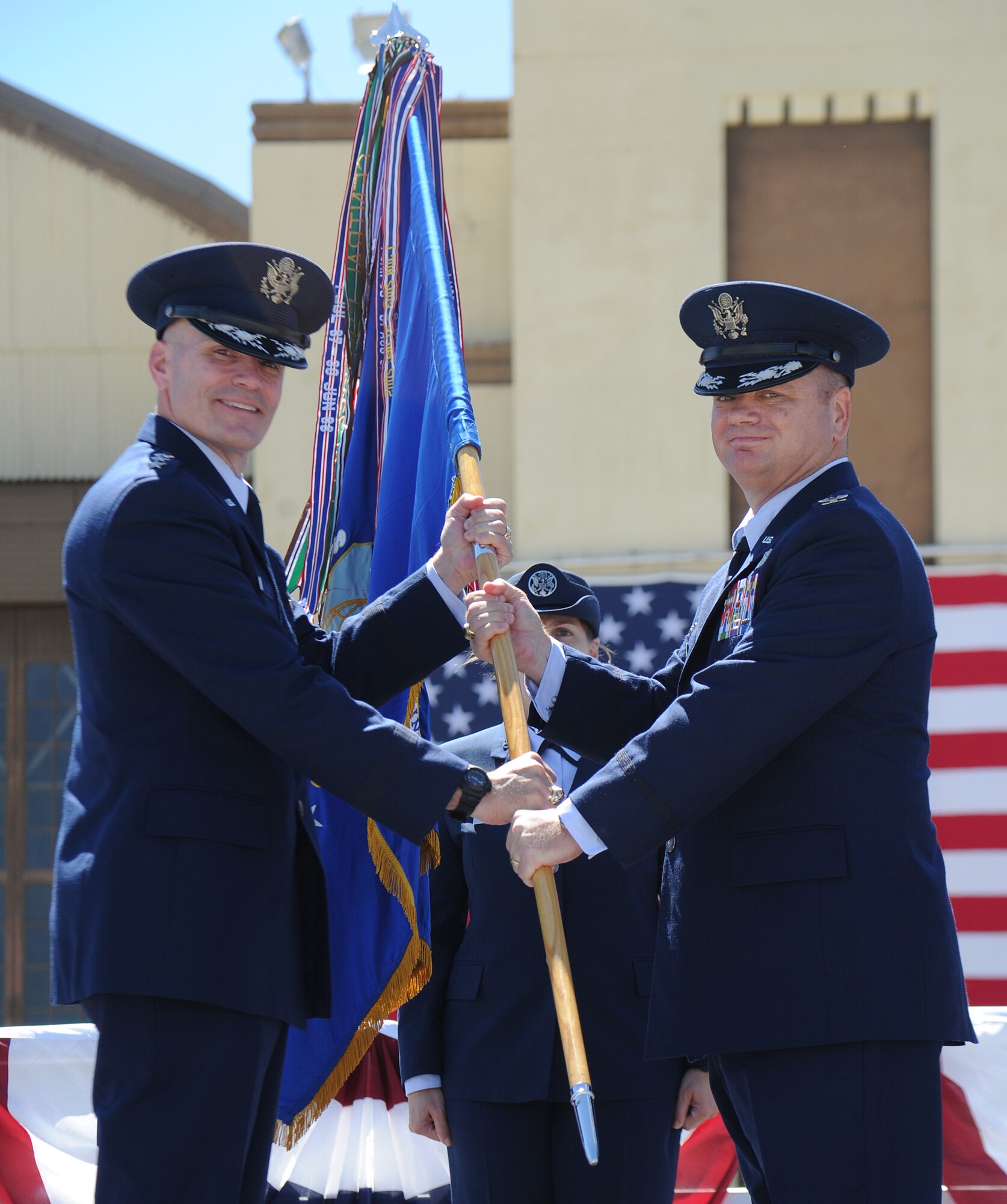 Lt. Gen. Carlton Everhart hands the guidon to Col. Charles “Brian” McDaniel during the 92nd Air Refueling Wing change of command at Fairchild Air Force Base, Washington, July 25, 2014. The change of command ceremony is a tradition that represents a formal transfer of authority and responsibility. Everhart is the 18th Air Force commander and McDaniel is the new 92nd ARW commander. (U.S. Air Force photo by Airman 1st Class Janelle Patiño/Released)