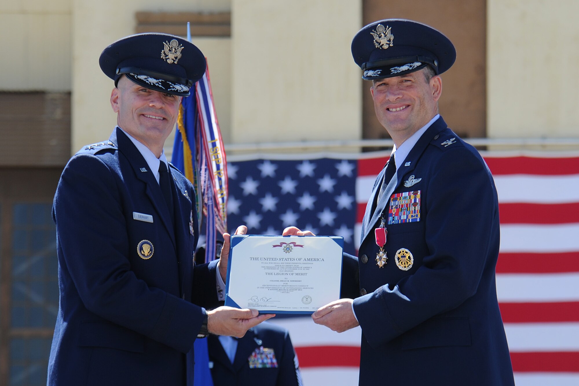 Lt. Gen. Carlton Everhart presents the Legion of Merit to Col. Brian Newberry during the 92nd Air Refueling Wing change of command at Fairchild Air Force Base, Washington, July 25, 2014. The Legion of Merit is awarded to members of armed forces of foreign nations for their meritorious conduct in the performance of outstanding services to the Government of the United States. Everhart is the 18th Air Force commander. (U.S. Air Force photo by Airman 1st Class Janelle Patiño/Released)