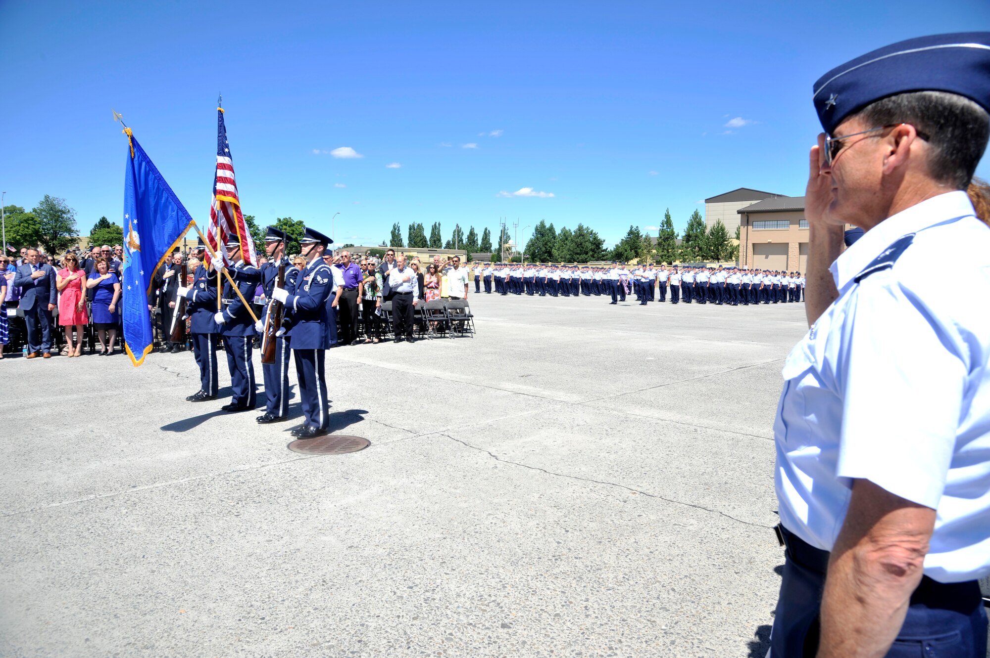 Brig. Gen. John Tuohy renders a salute as Team Fairchild honor guard members present the colors during the 92nd Air Refueling Wing change of command ceremony at Fairchild Air Force Base, Washington, July 25, 2014. Guests of the commanders' included family, friends and community leaders from around Washington state. Tuohy is the Washington Air National Guard assistant adjutant general for air. (U.S. Air Force photo by Senior Airman Mary O'Dell/Released)