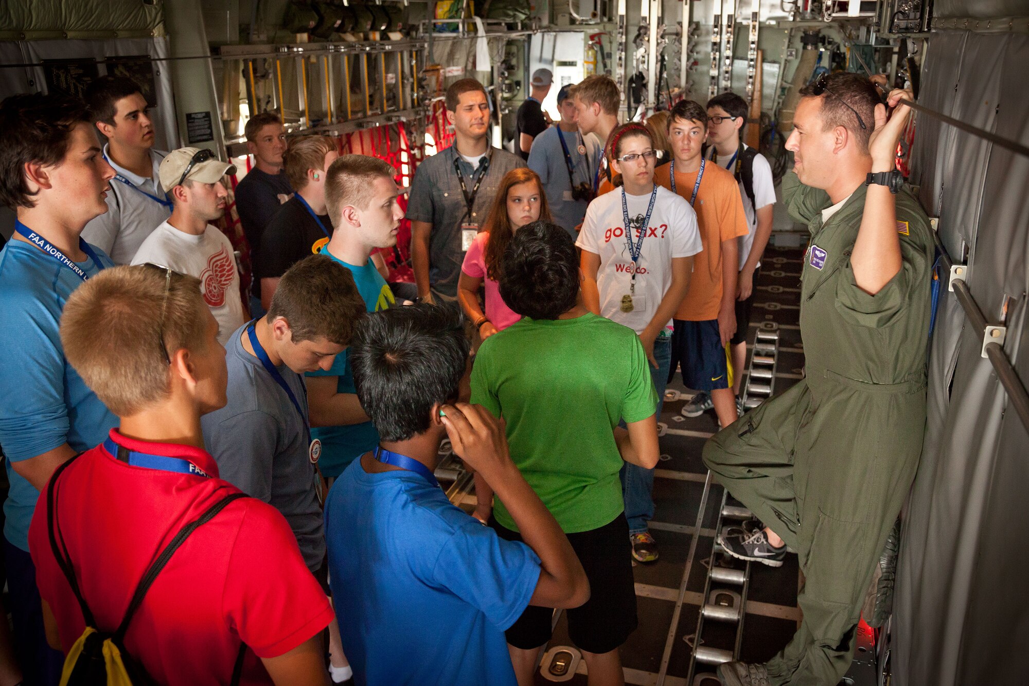 Senior Airman Brian Beckmann, 96th Airlift Squadron, answers questions during a tour of a C-130 aircraft, capping off a week of activities for the Minnesota Aviation Career Education program.  The 934th Airlift Wing hosted the ACE Camp, which is held each year in June and July for high school students interested in aviation careers.  (U.S. Air Force photo/Shannon McKay)