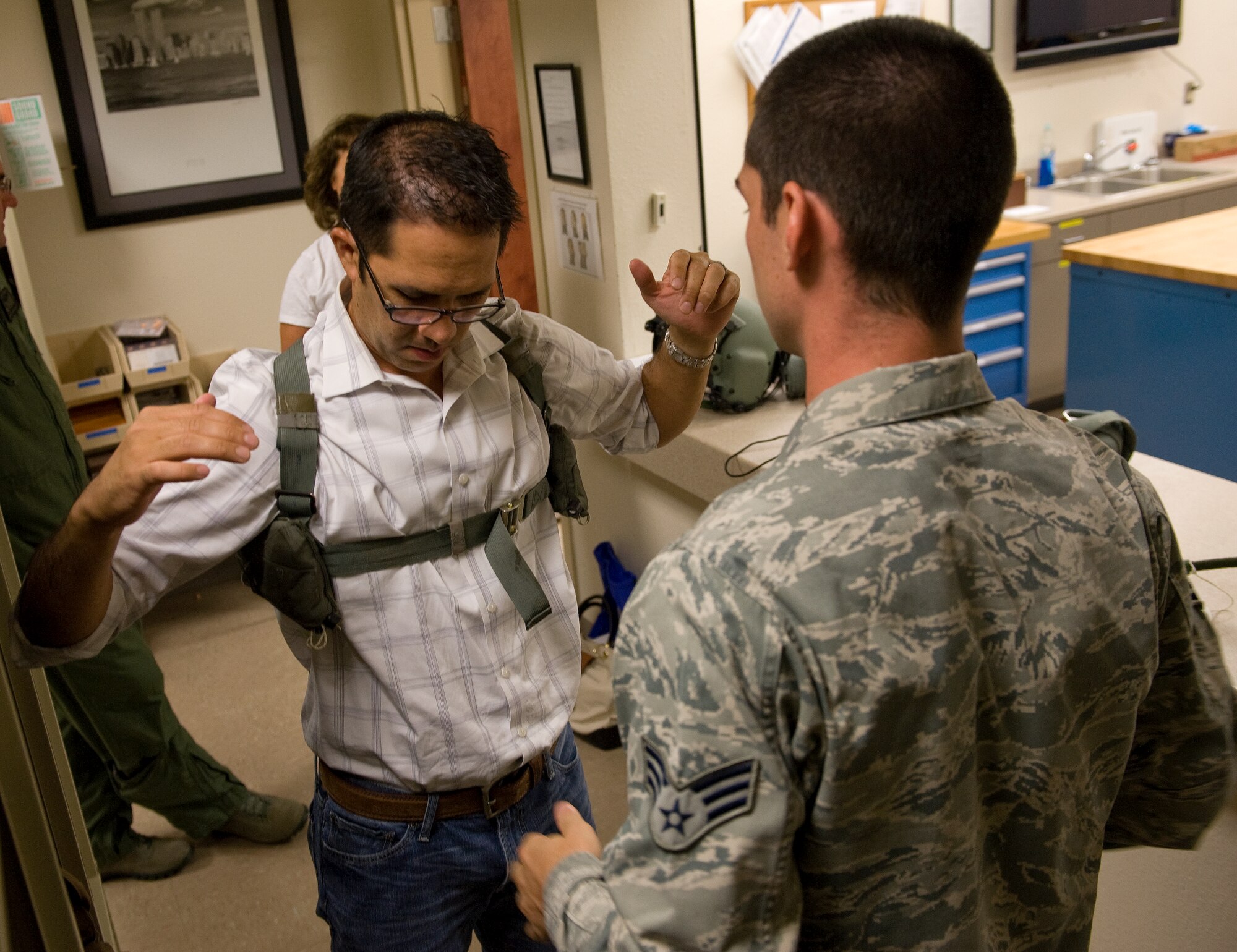 Hayward Dykes Jr., 24th Special Operations Wing honorary commander, is fitted with a flight harness at the 8th SOS squadron on Hurlburt Field, Fla., July 22, 2014. The harness helps hold personnel in place once they board an aircraft but movement is still possible. (U.S. Air Force photo/Senior Airman Kentavist P. Brackin)