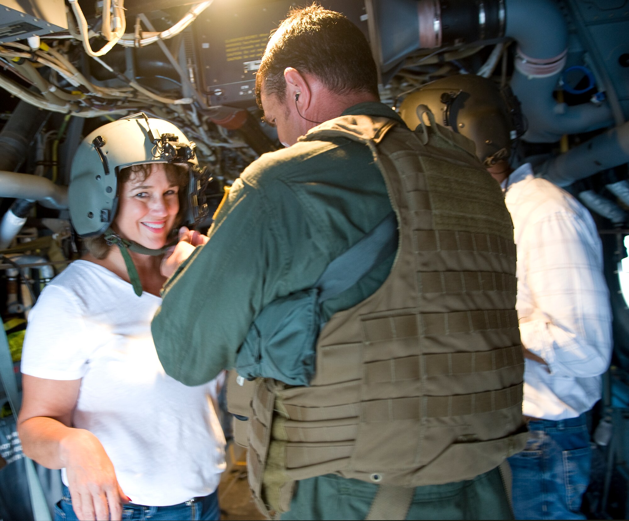 Cindy Gates, Hurlburt Field honorary commander, is fitted with a Kevlar helmet onboard a CV-22 Osprey tilt-rotor aircraft at the flightline on Hurlburt Field, Fla., July 22, 2014. “It was a great experience to get a chance to fly onboard one of these,” said Gates. “My students are going to be so jealous.” (U.S. Air Force photo/Senior Airman Kentavist P. Brackin)