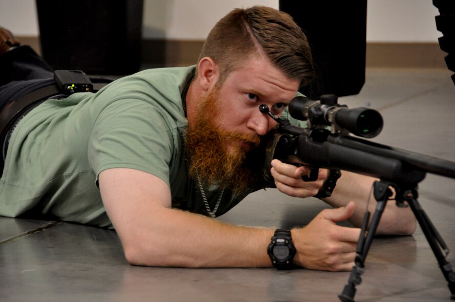 Sean Doolittle, Oakland A's pitcher, practices his aim July 21 at the Travis Air Force Contingency Response Wing. Doolittle was given a tour of the CRW that involved humvees, weapons and response equipment. (U.S. Air Force photo by Airman 1st Class Amber Carter)
